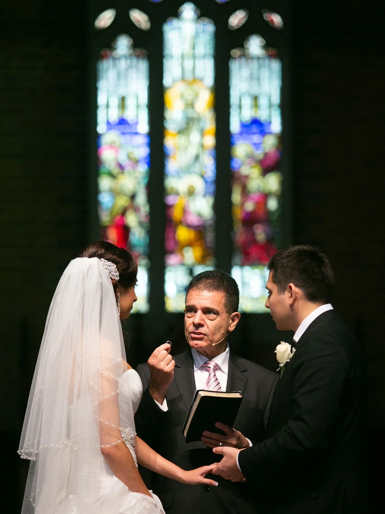 Ring exchange in front of stained glass windows St Matthews Anglican Church Manly