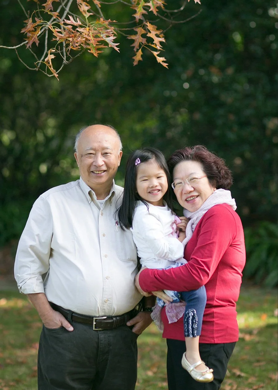 Grandparents with young granddaughter in autumn