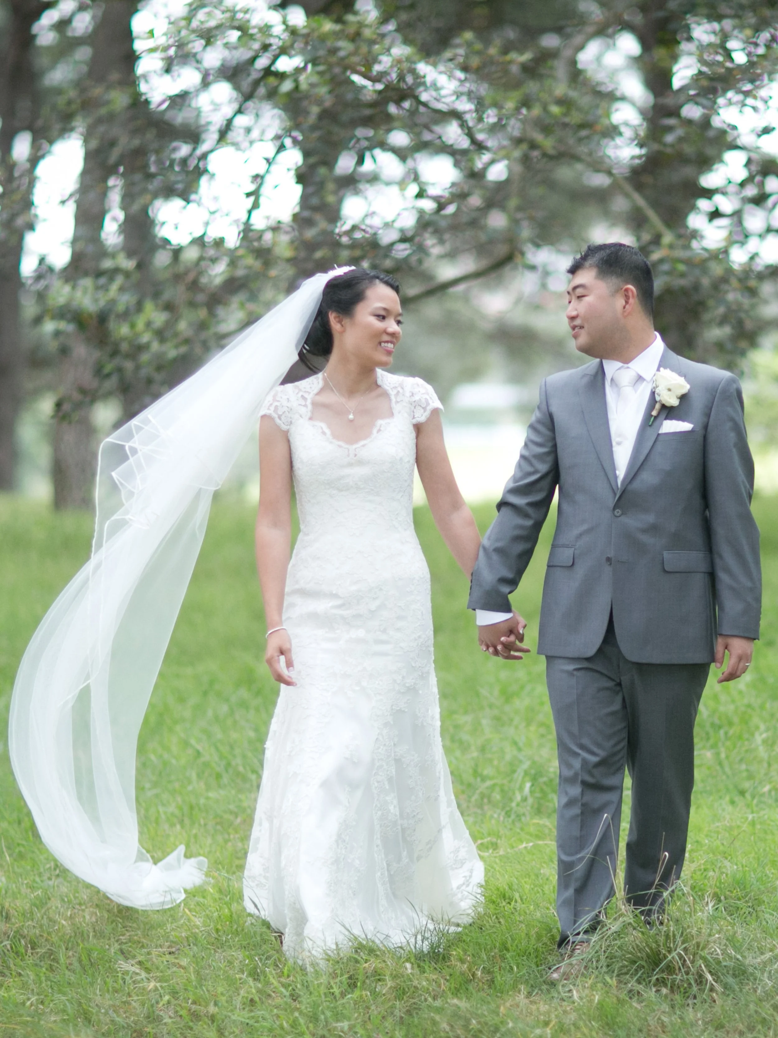 Bride and groom walking together Centennial Park pine forest 