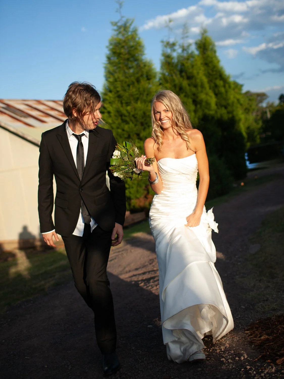 Couple walking portrait to praivate garden reception