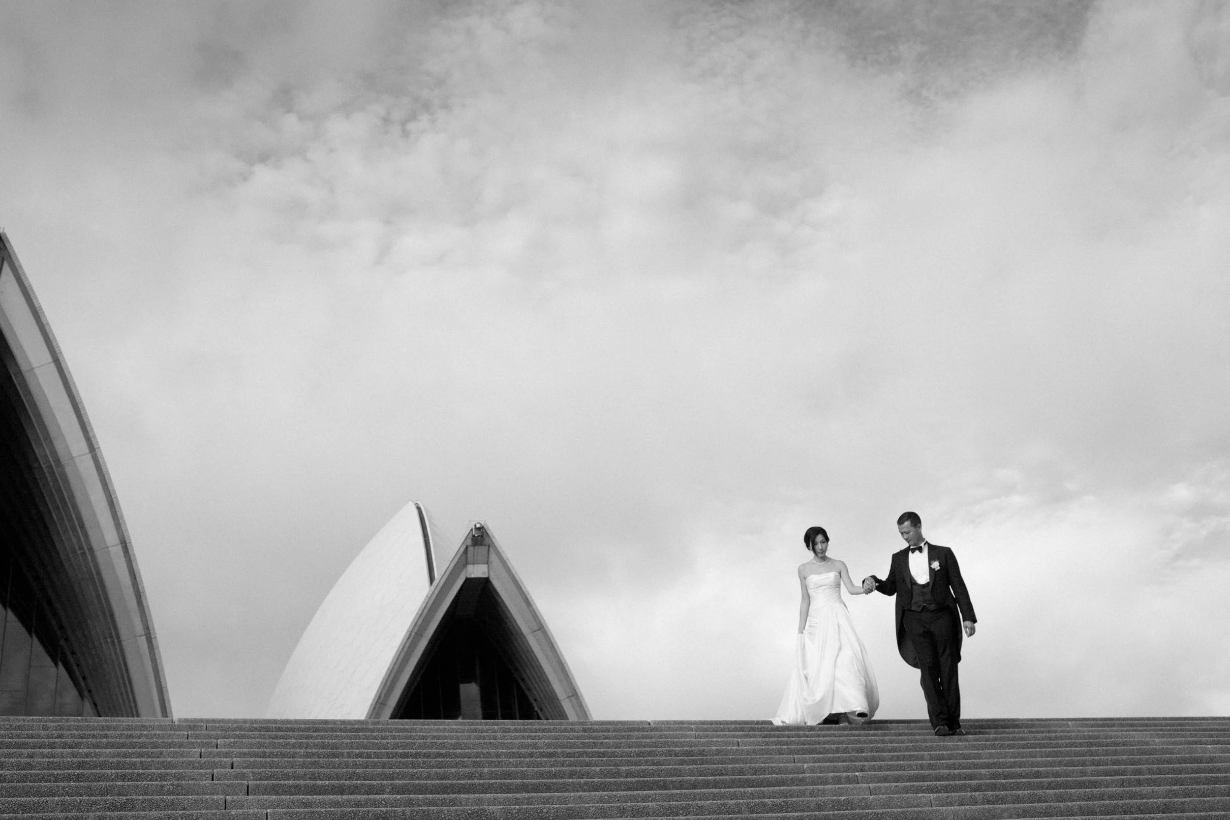 groom-walking-bride-down-opera-house-stairs-sydney-wedding-photography.jpg