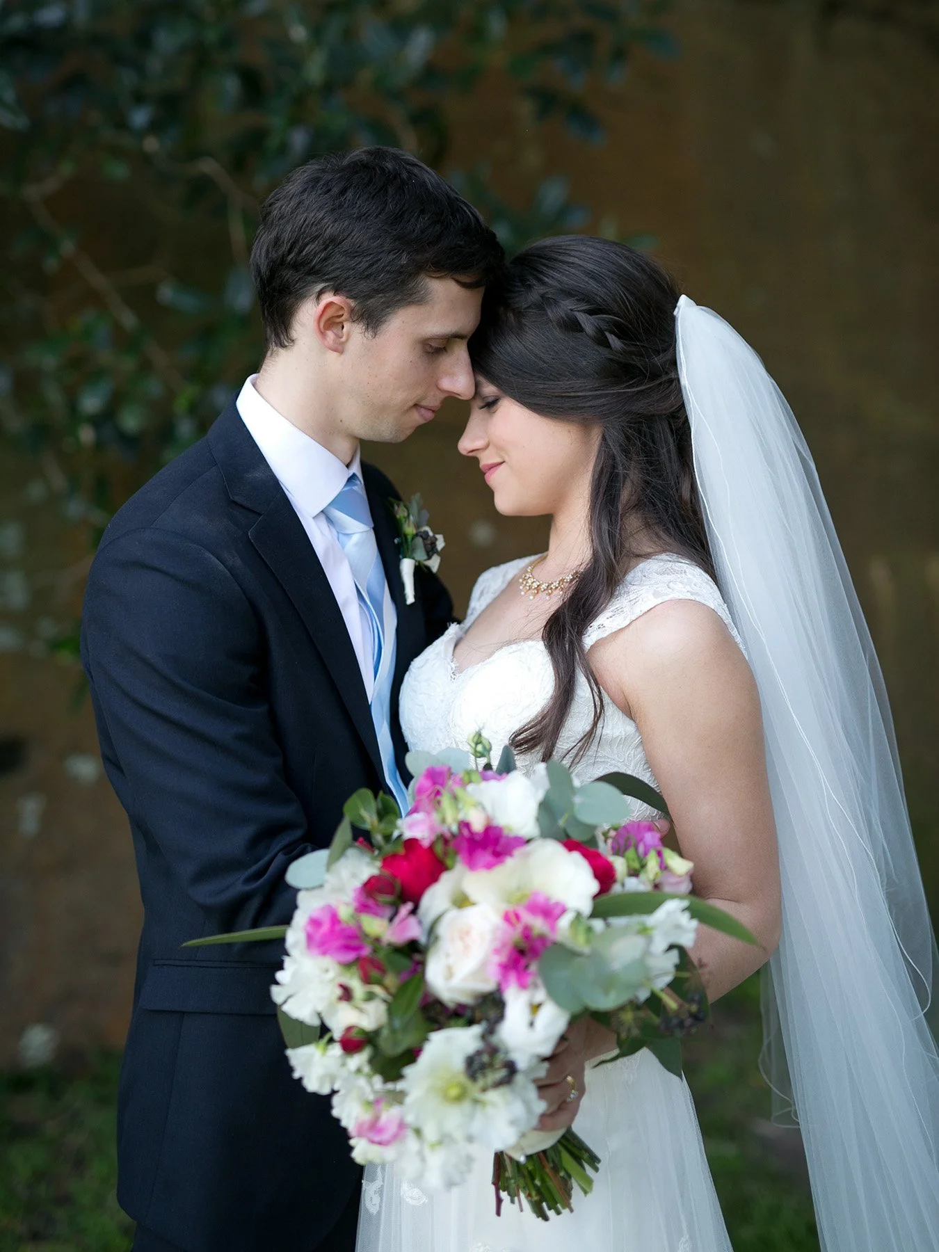 Bride and groom foreheads touching at Bradleys Head Mosman