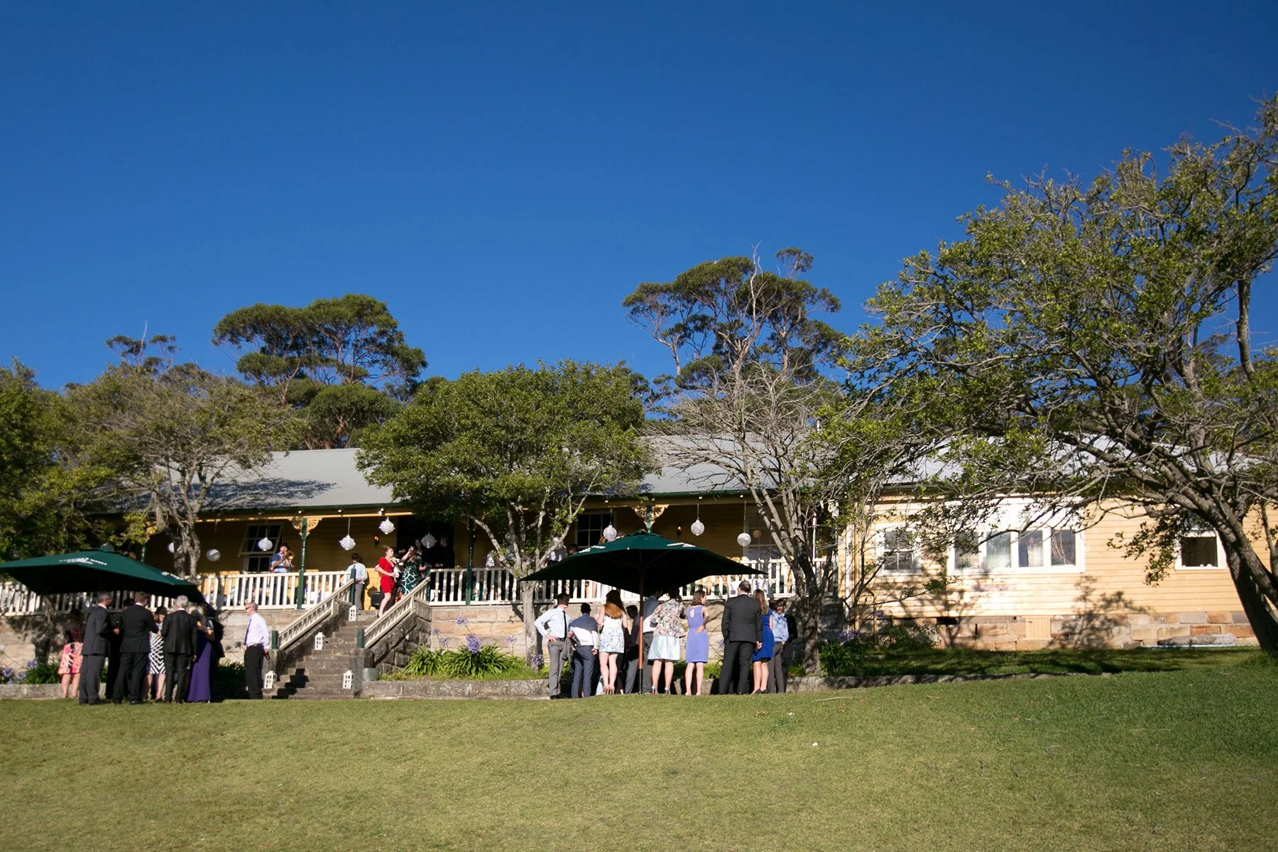 Athol Hall Mosman reception exterior with guests, bright blue sky