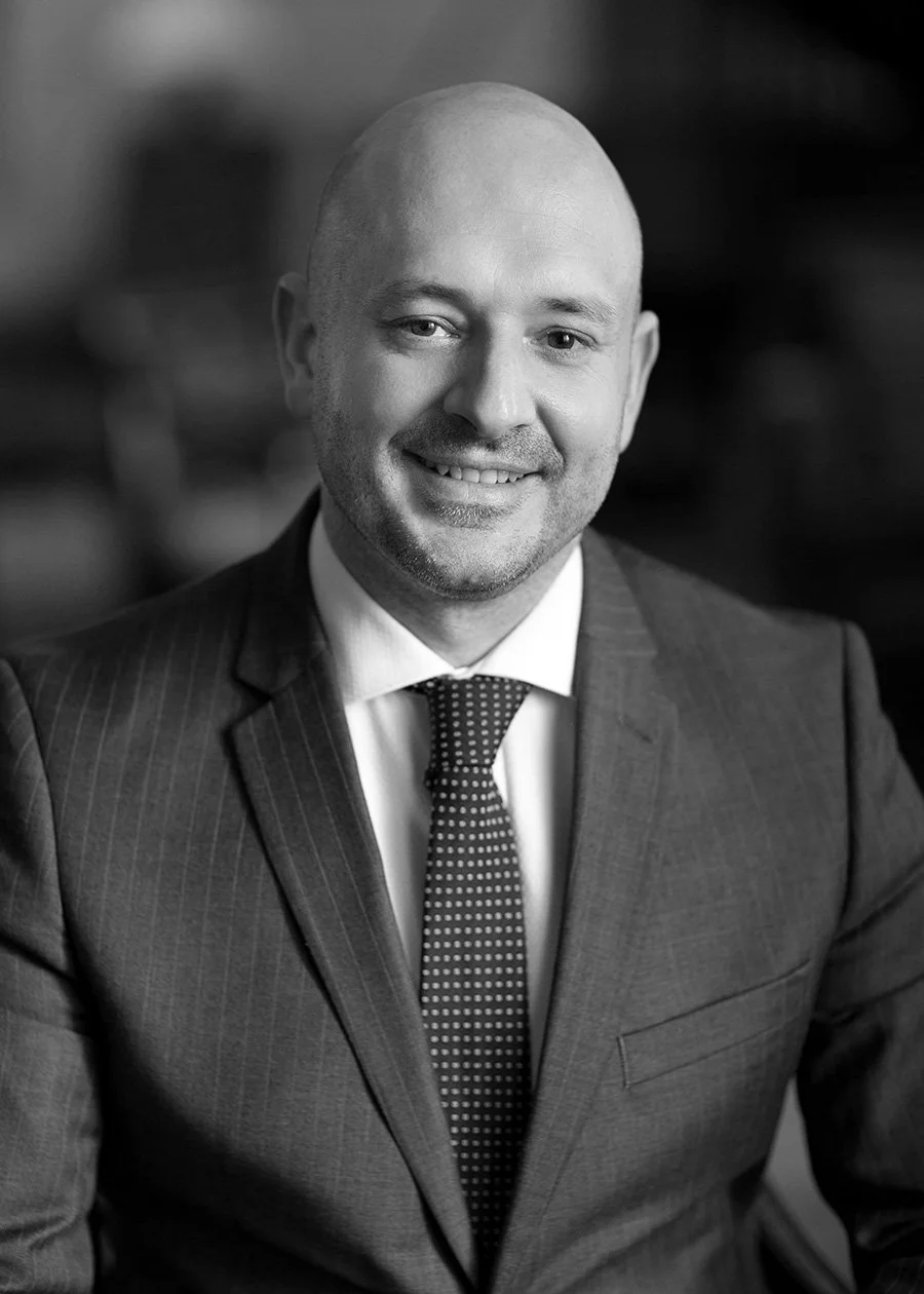 Richard relaxed black and white corporate headshot in a business lounge