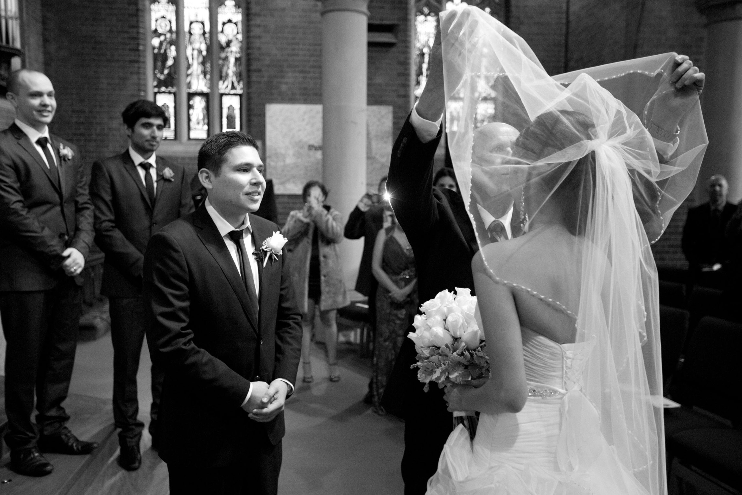 Groom unveiling bride during ceremony, St Matthews Anglican Church Manly