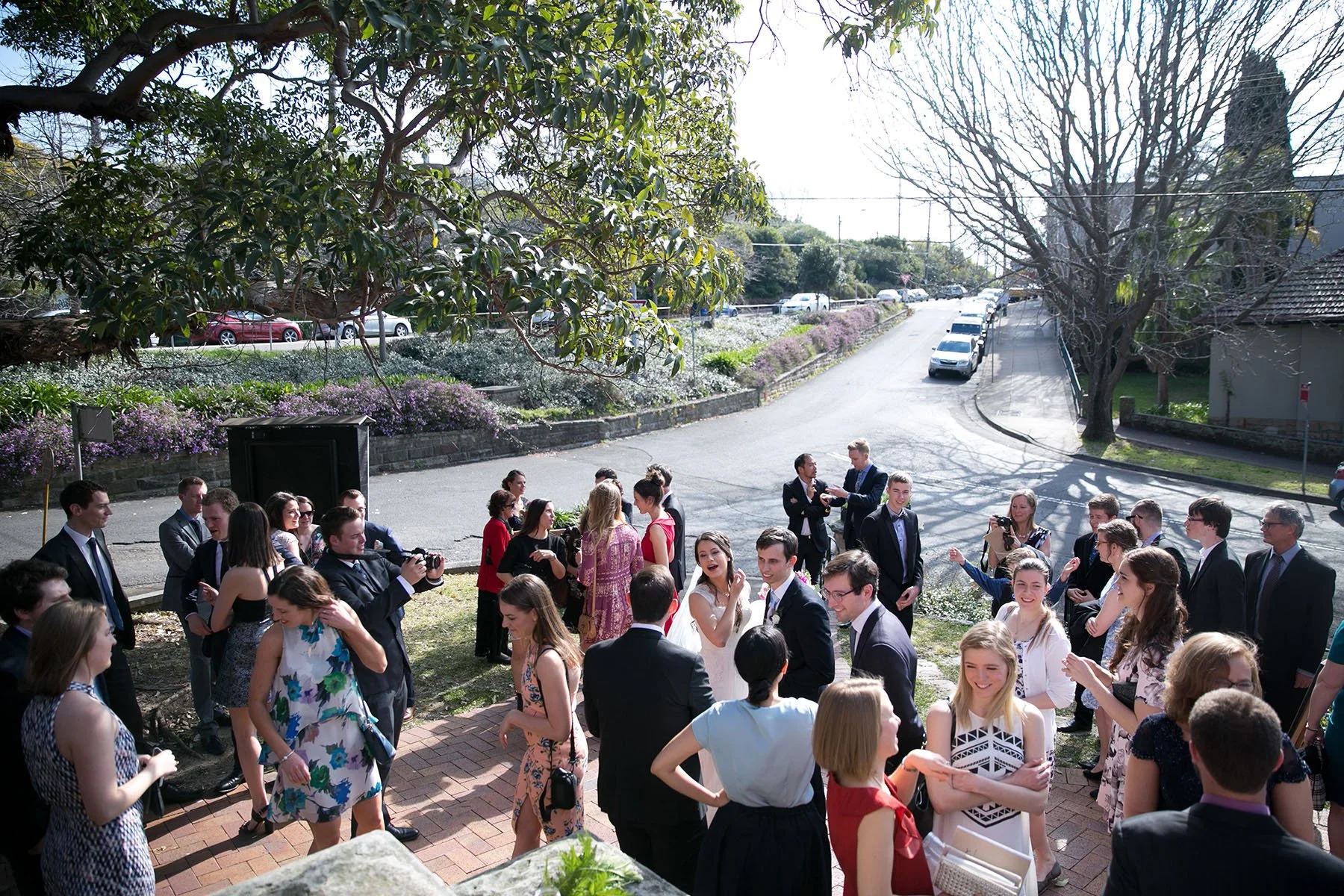 Wedding guests gathered on the grounds after the ceremony, St Andrews Anglican Church Roseville