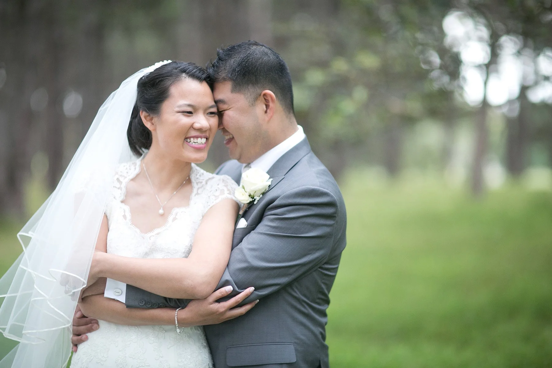 Bride and groom laughing together Centennial Park Sydney wedding portrait