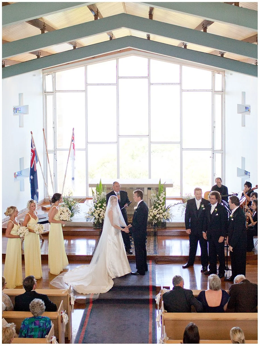 Couple at altar holding hands, HMAS Watson chapel, Watsons Bay