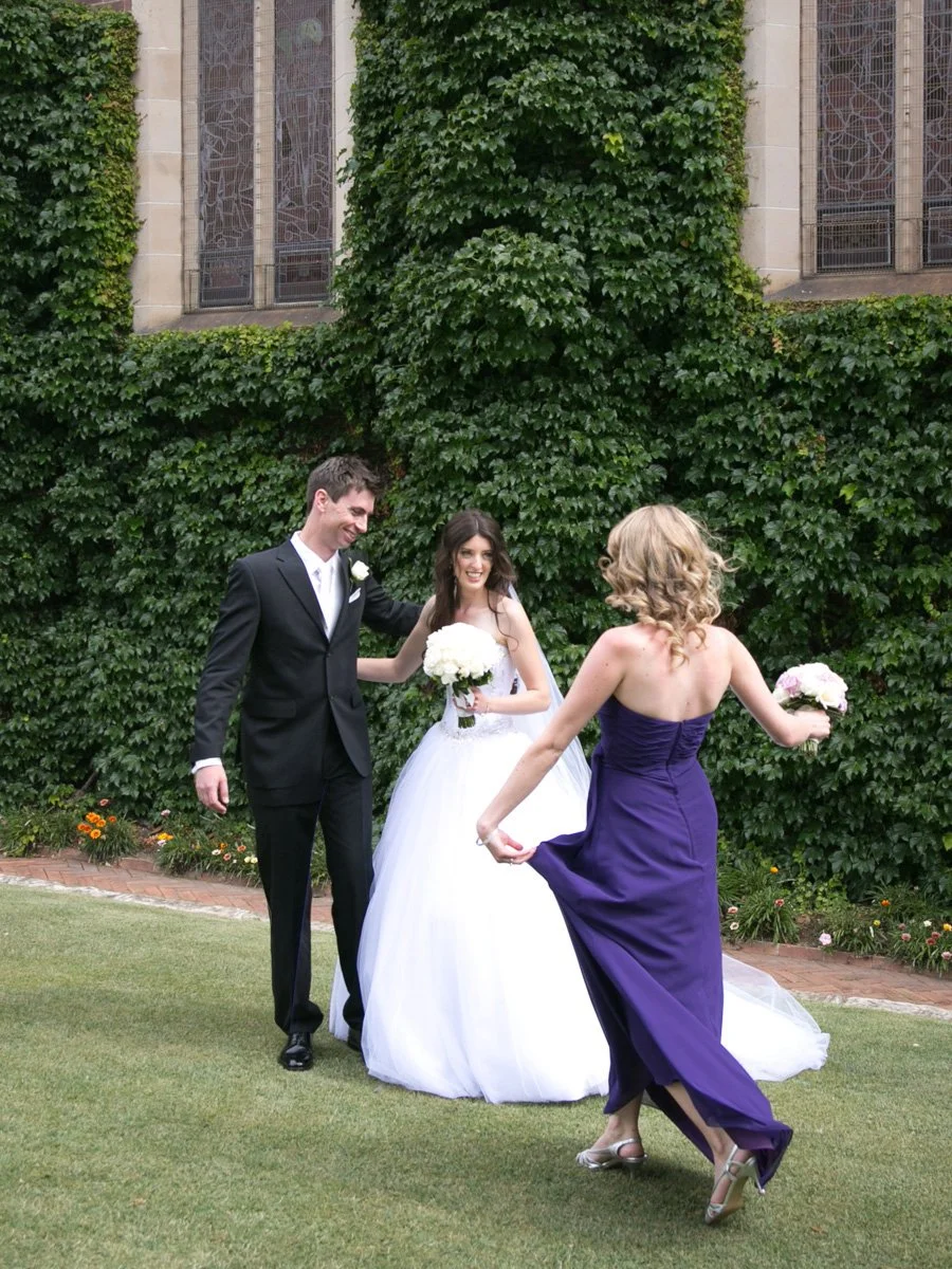 Bridemaid joy running to bride at Shore School Chapel grounds, North Sydney