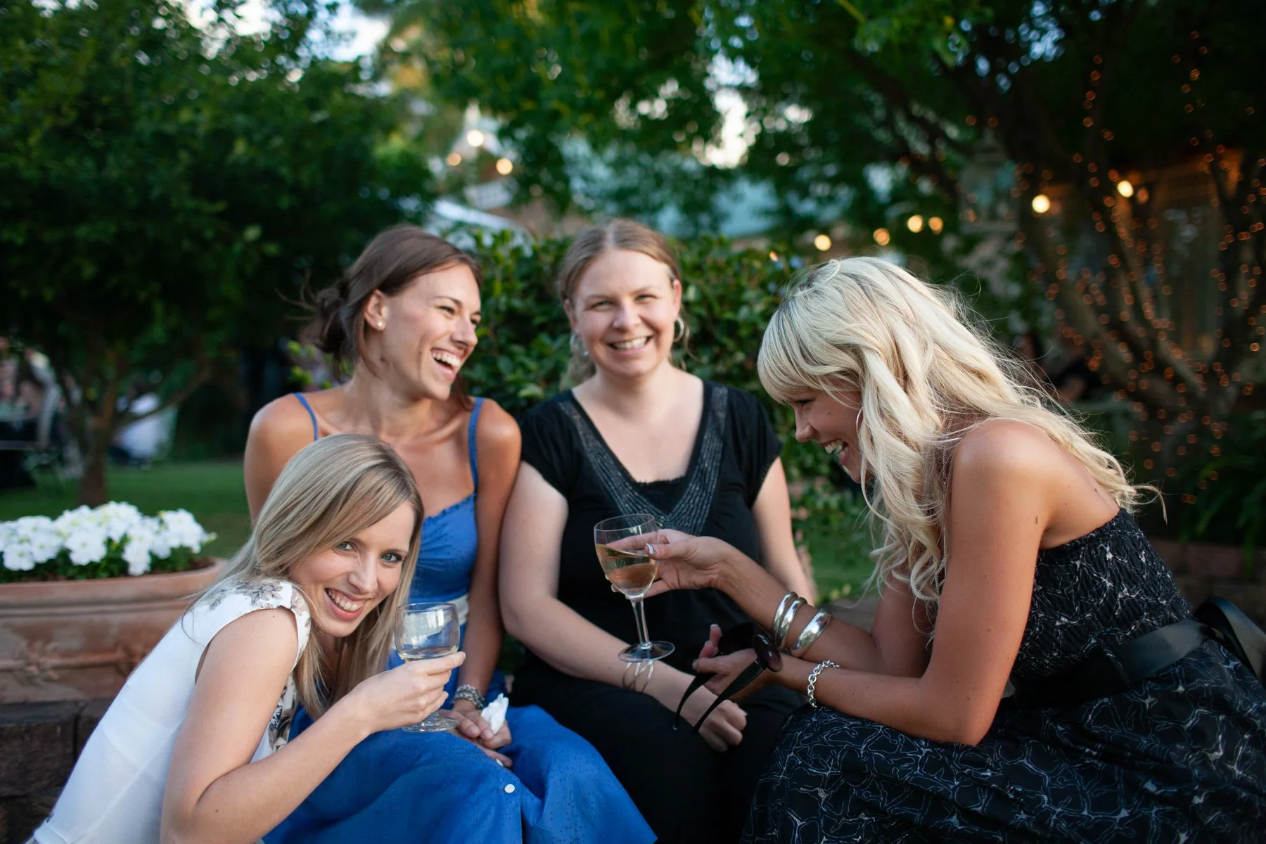 Guests laughing at outdoor garden reception 