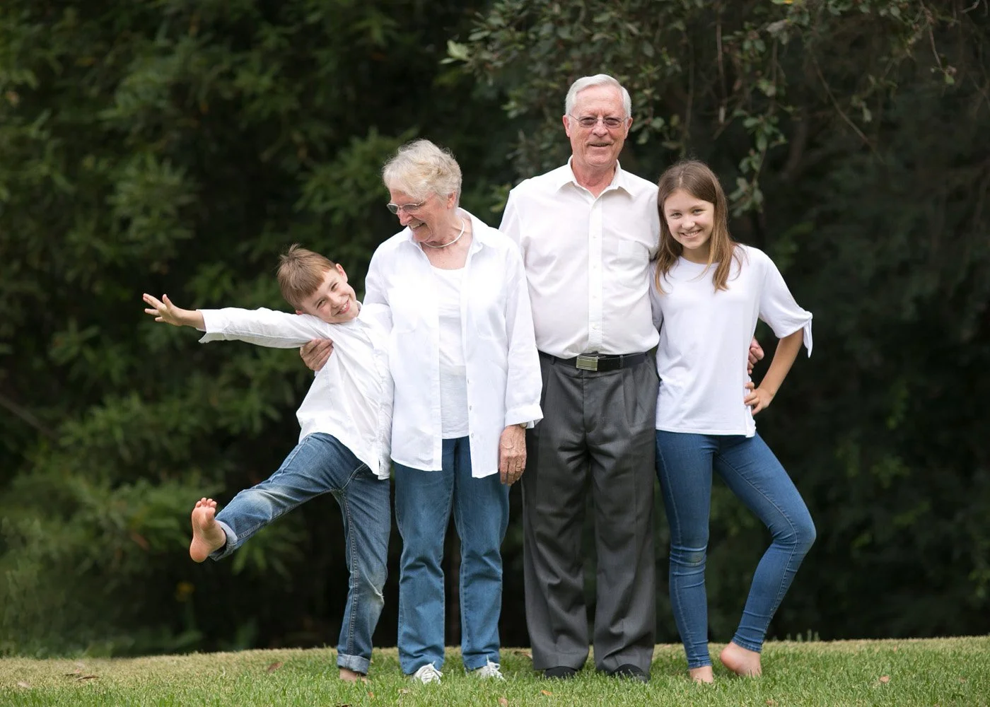 Grandparents with two grandchildren in backyard
