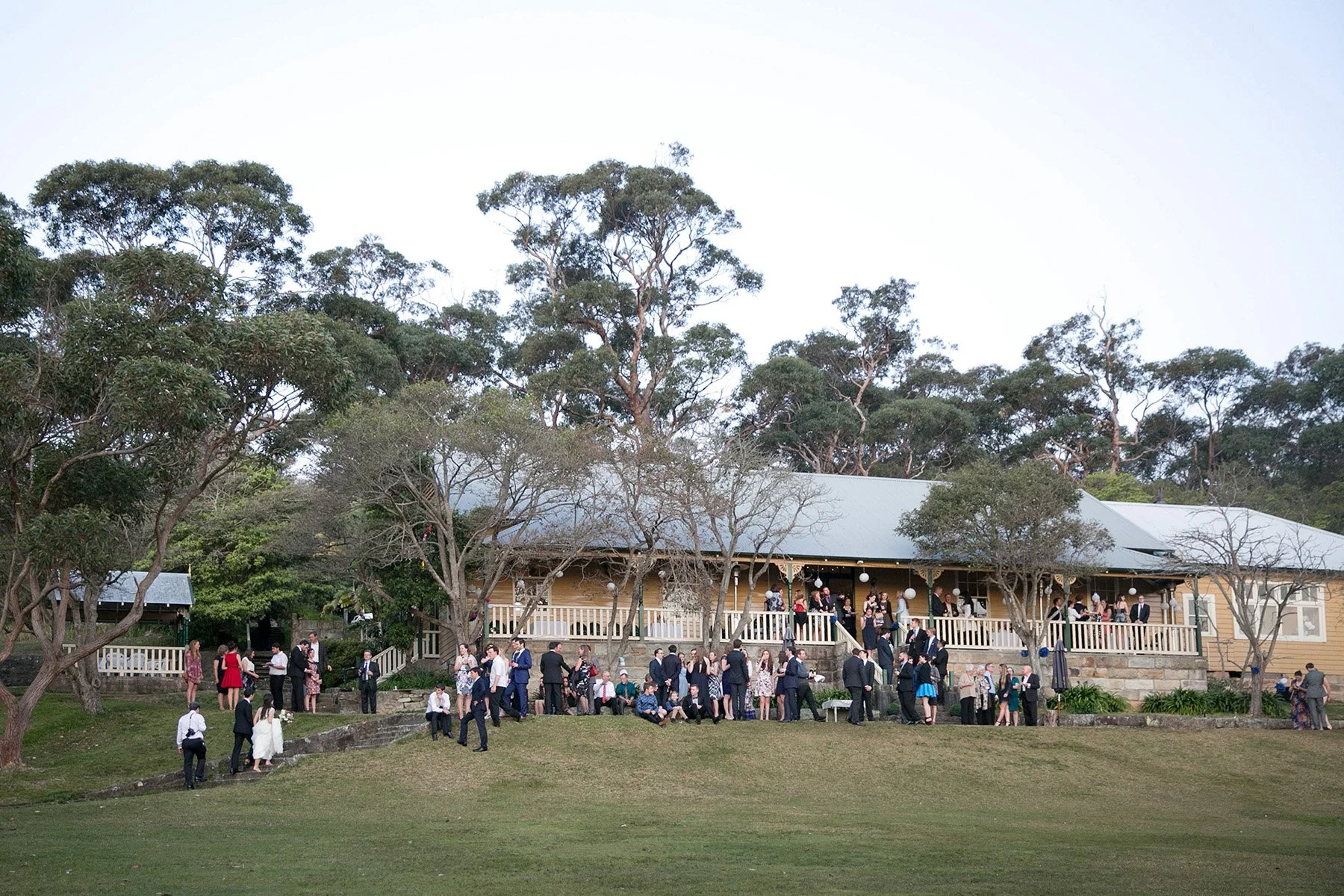 Wedding guests mingling on the lawn during the cocktail hour, Athol Hall Mosman