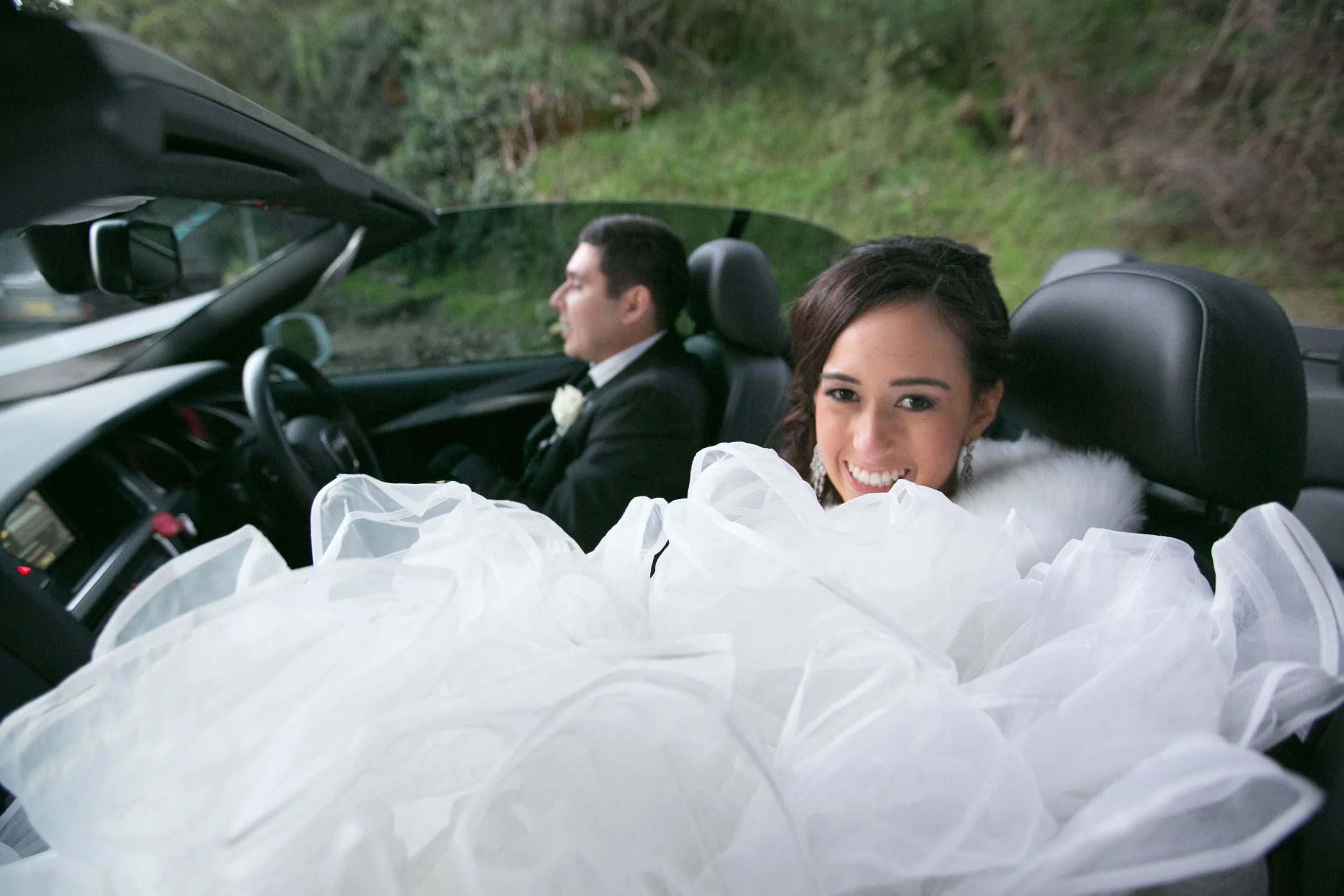 Bride smiling in convertible at Bradleys Head Mosman
