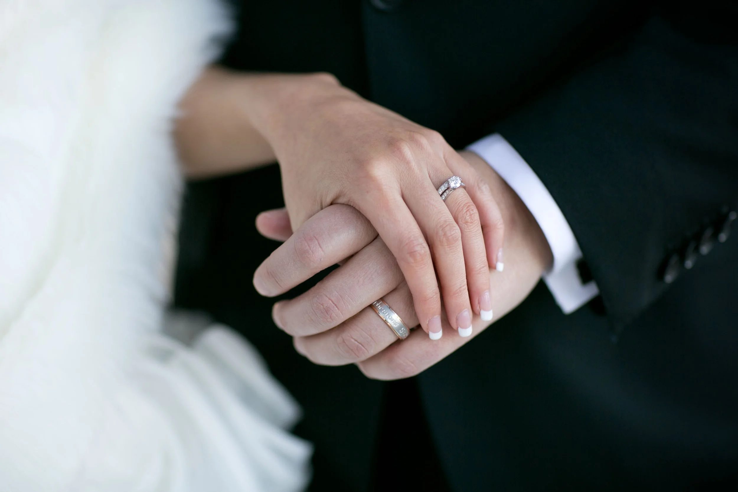 Wedding rings and hands detail at Balmoral Beach