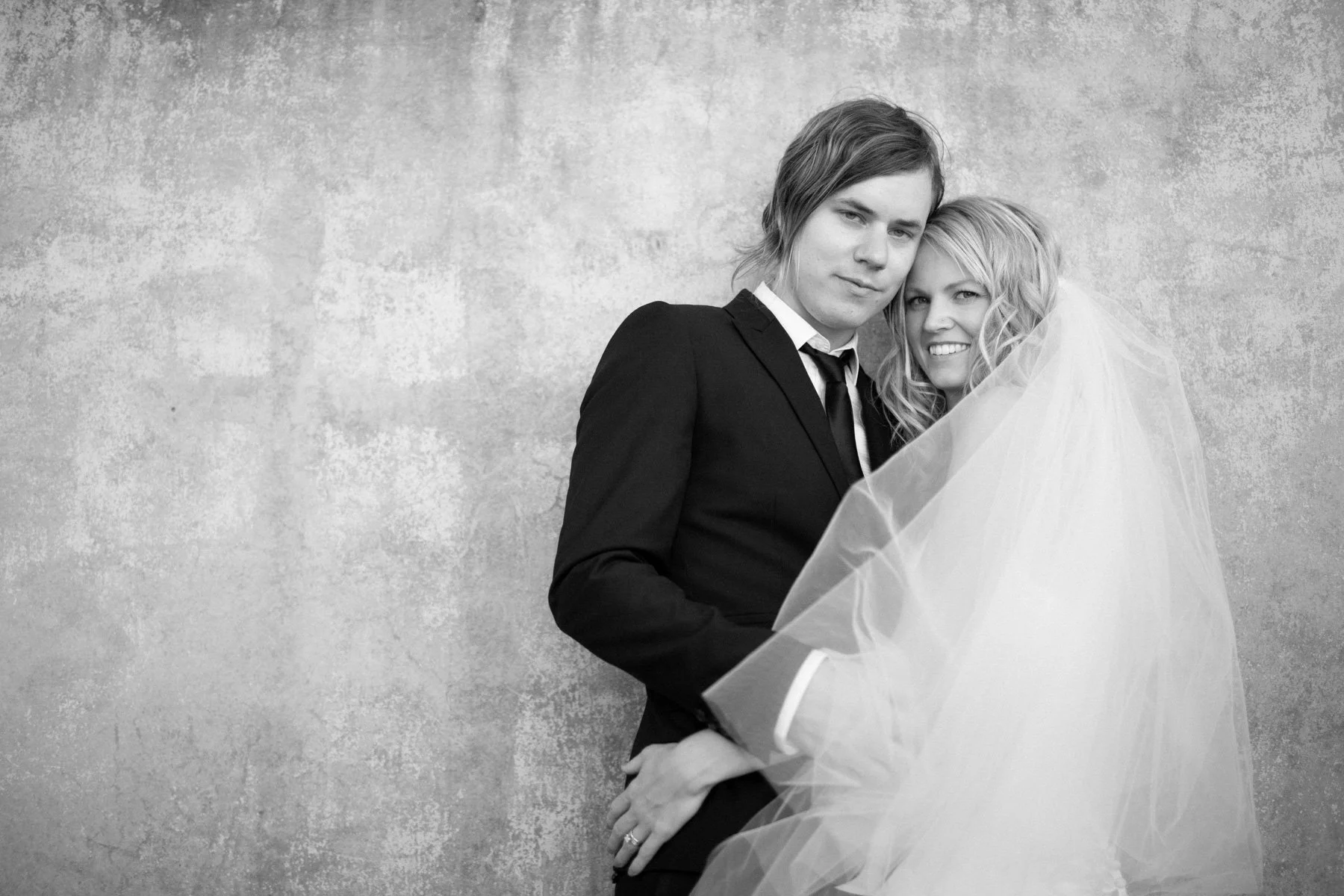 Groom and bride standing against a wall location photograph, The Rocks Sydney