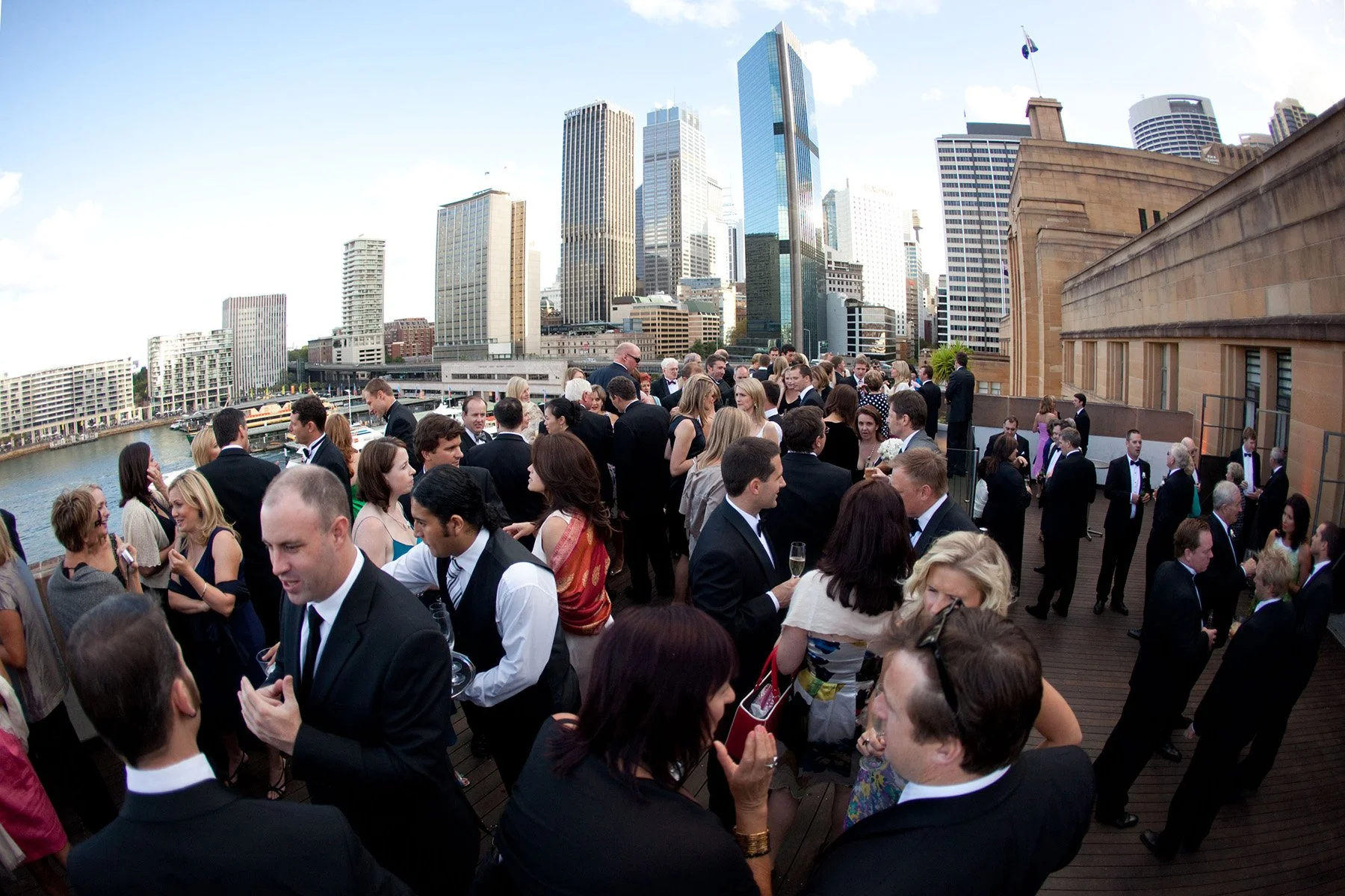 Wedding guests on the rooftop terrace of the Museum of Contemporary Art overlooking Circular Quay