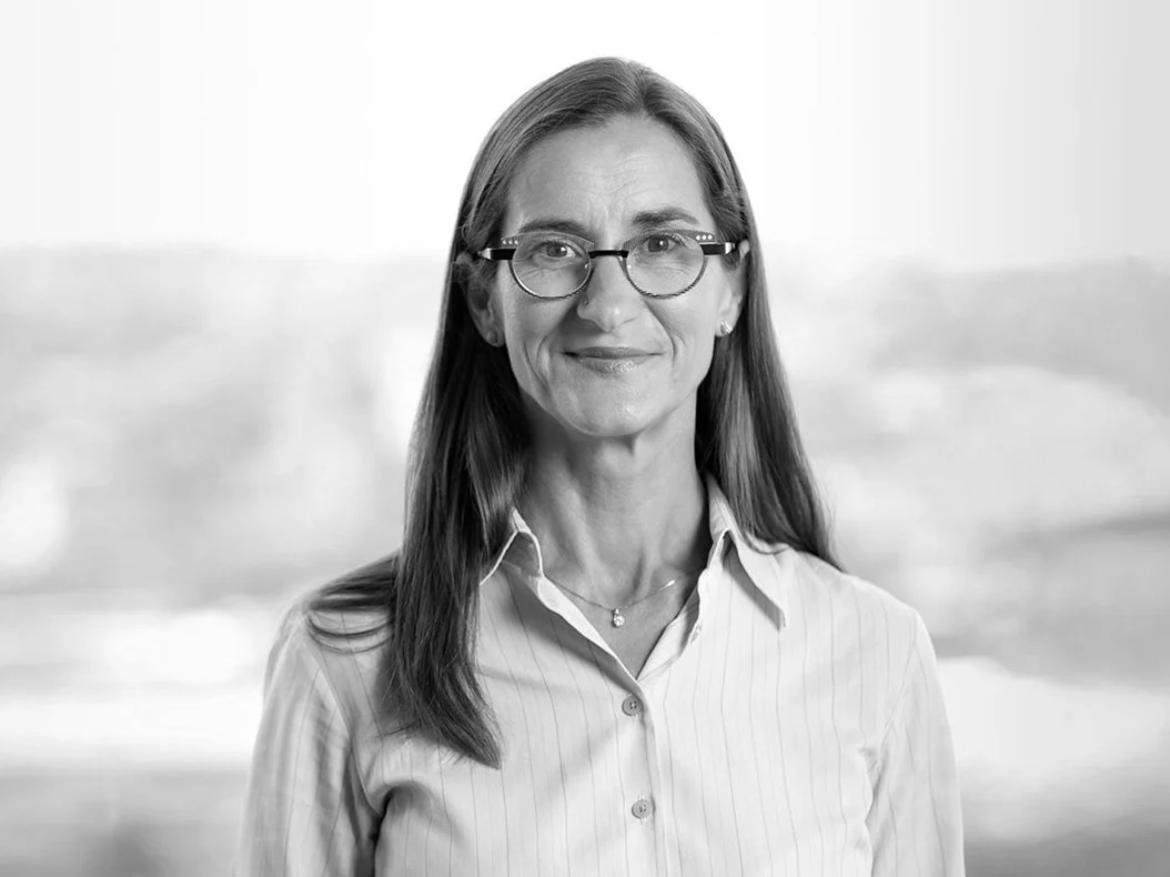 Petra black and white corporate headshot in a city boardroom