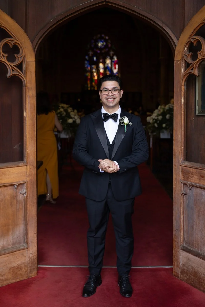Groom at the Garrison Church, Millers Point, stained glass behind him