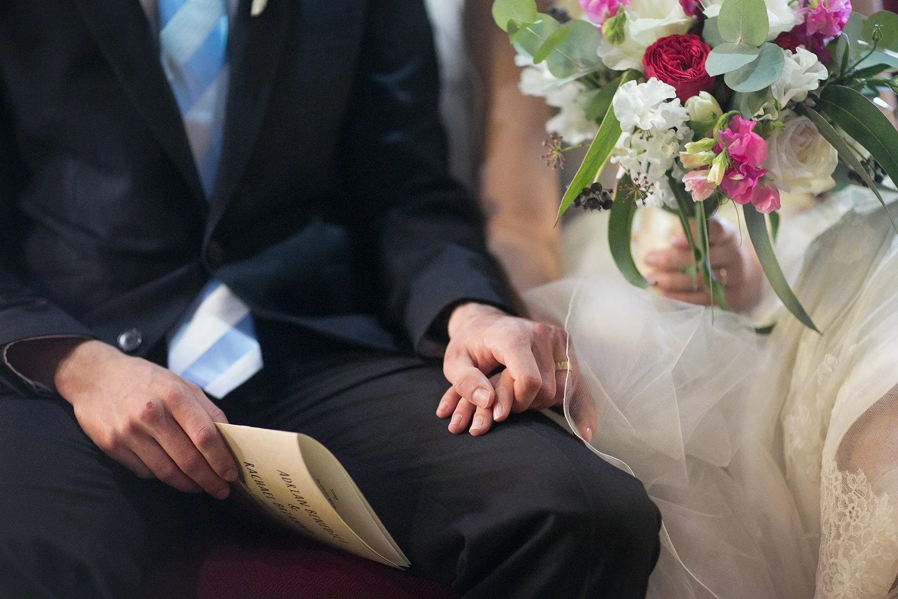 Hand and bouquet detail of husband and wife seated at St Andrews Anglican Church Roseville