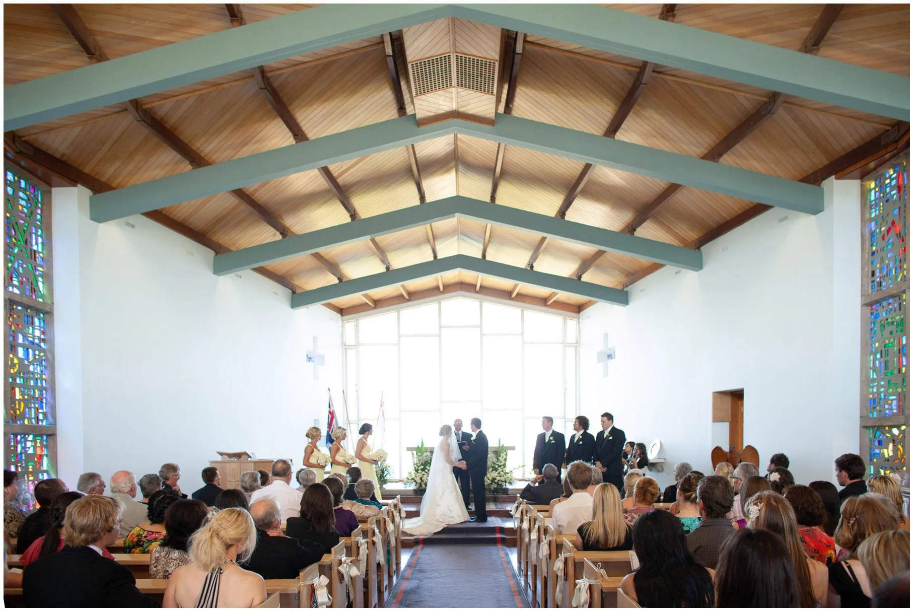 Entire bridal party during wedding vows, HMAS Watson chapel, Watsons Bay