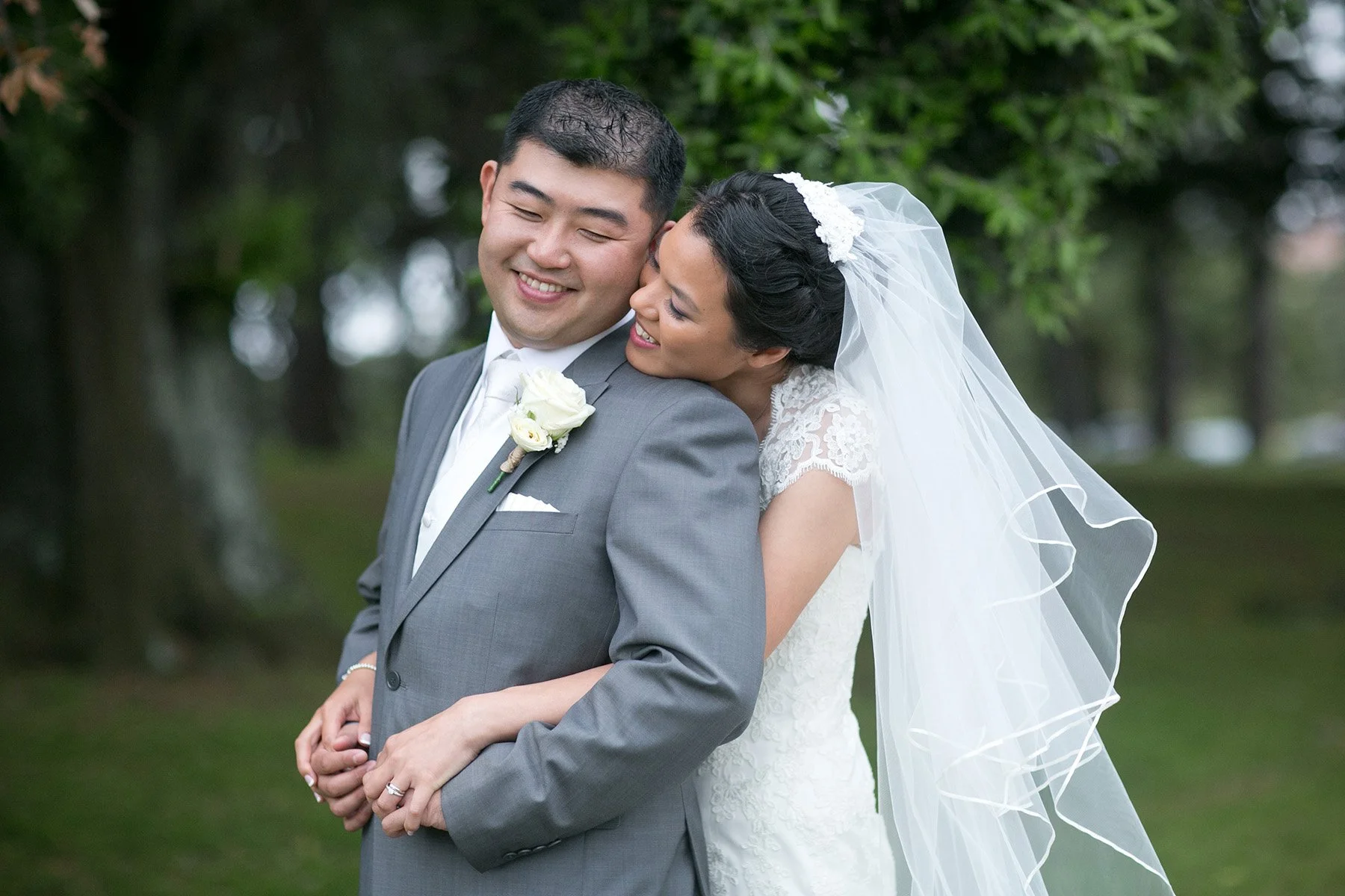 Bride embracing groom Centennial Park Sydney wedding portrait session