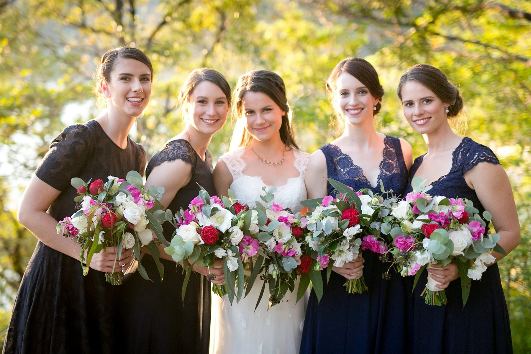 Bridesmaids holding their bouquets in a group portrait at Bradleys Head Mosman