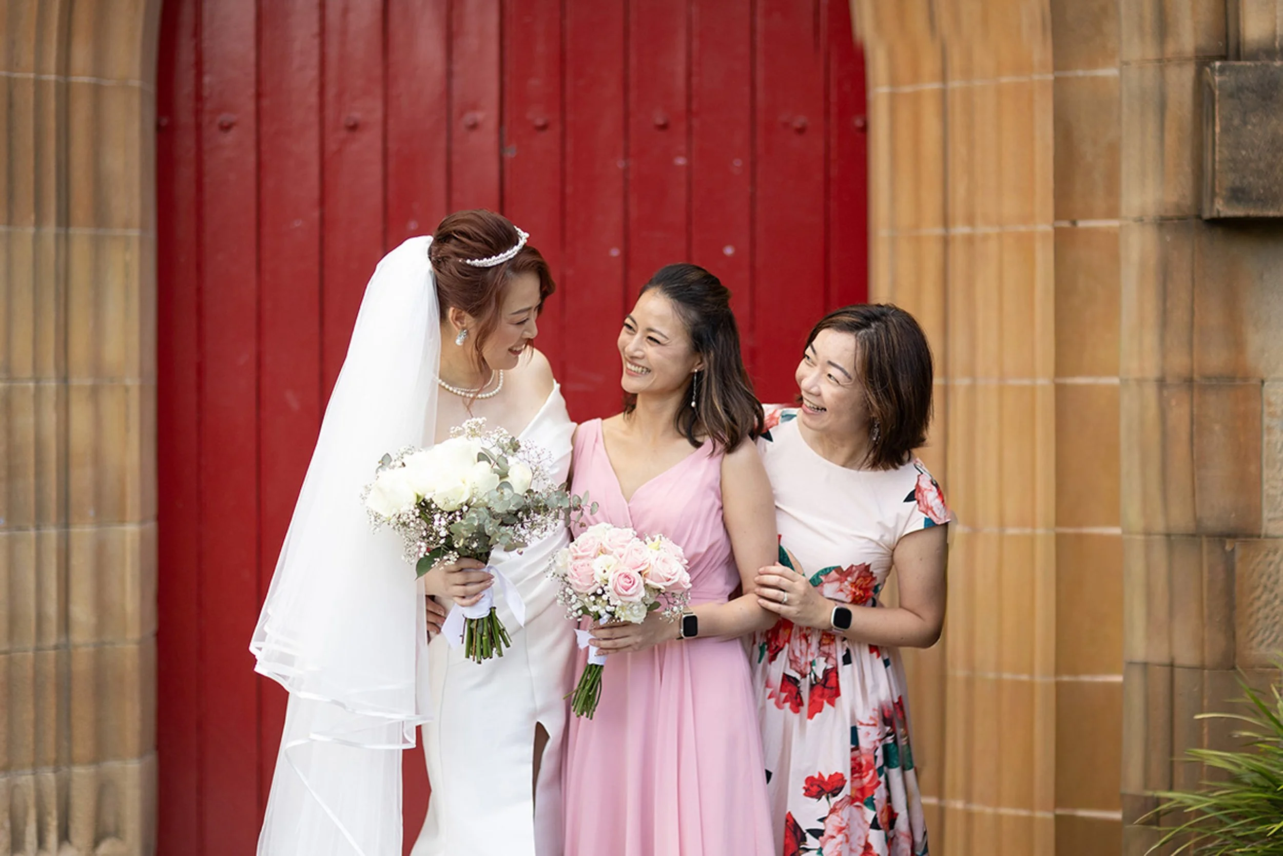 Bride with bridesmaids at the Garrison Church red door, Millers Point