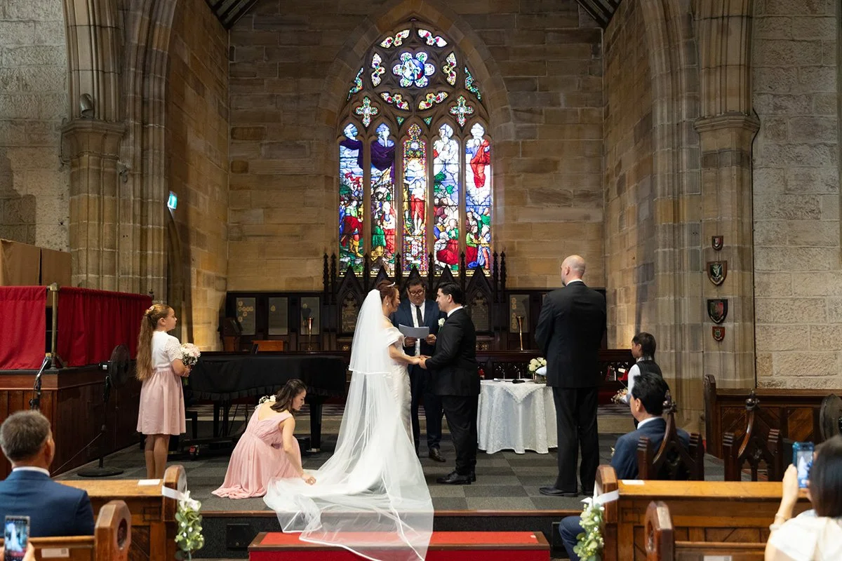 Couple at the altar, full veil trailing, Garrison Church, Millers Point