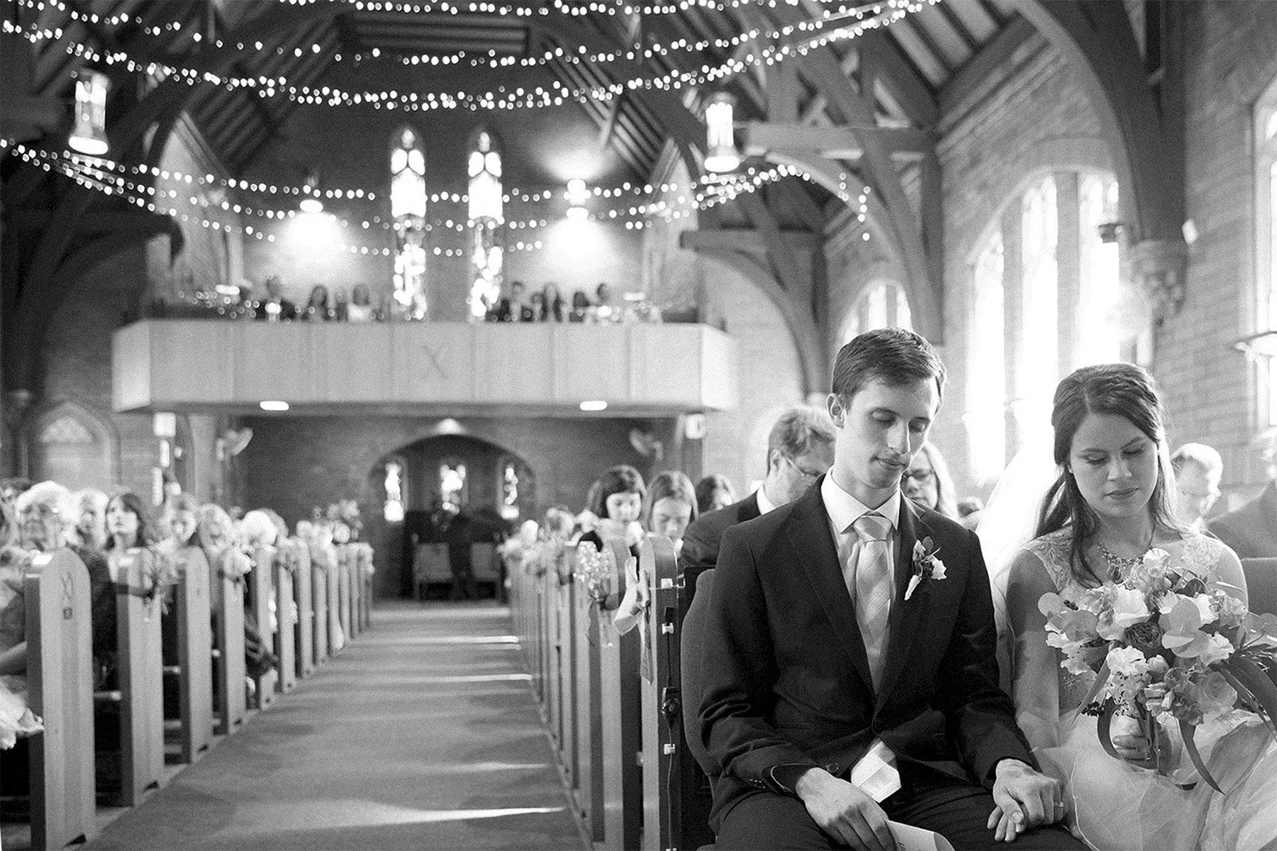 Marriage prayer groom and bride seated at St Andrews Anglican Church Roseville
