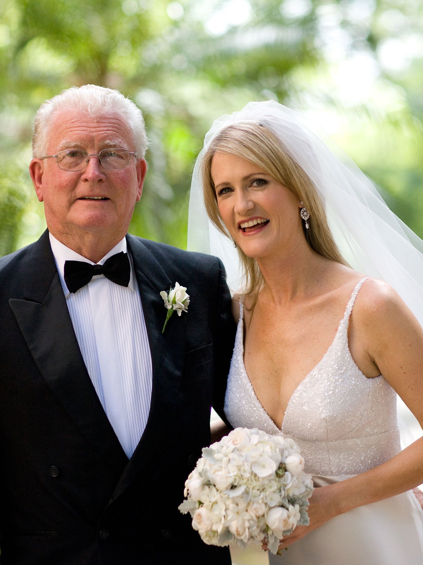 Bride holding a white bouquet beside her father before the processional, All Saints Anglican Church Woollahra