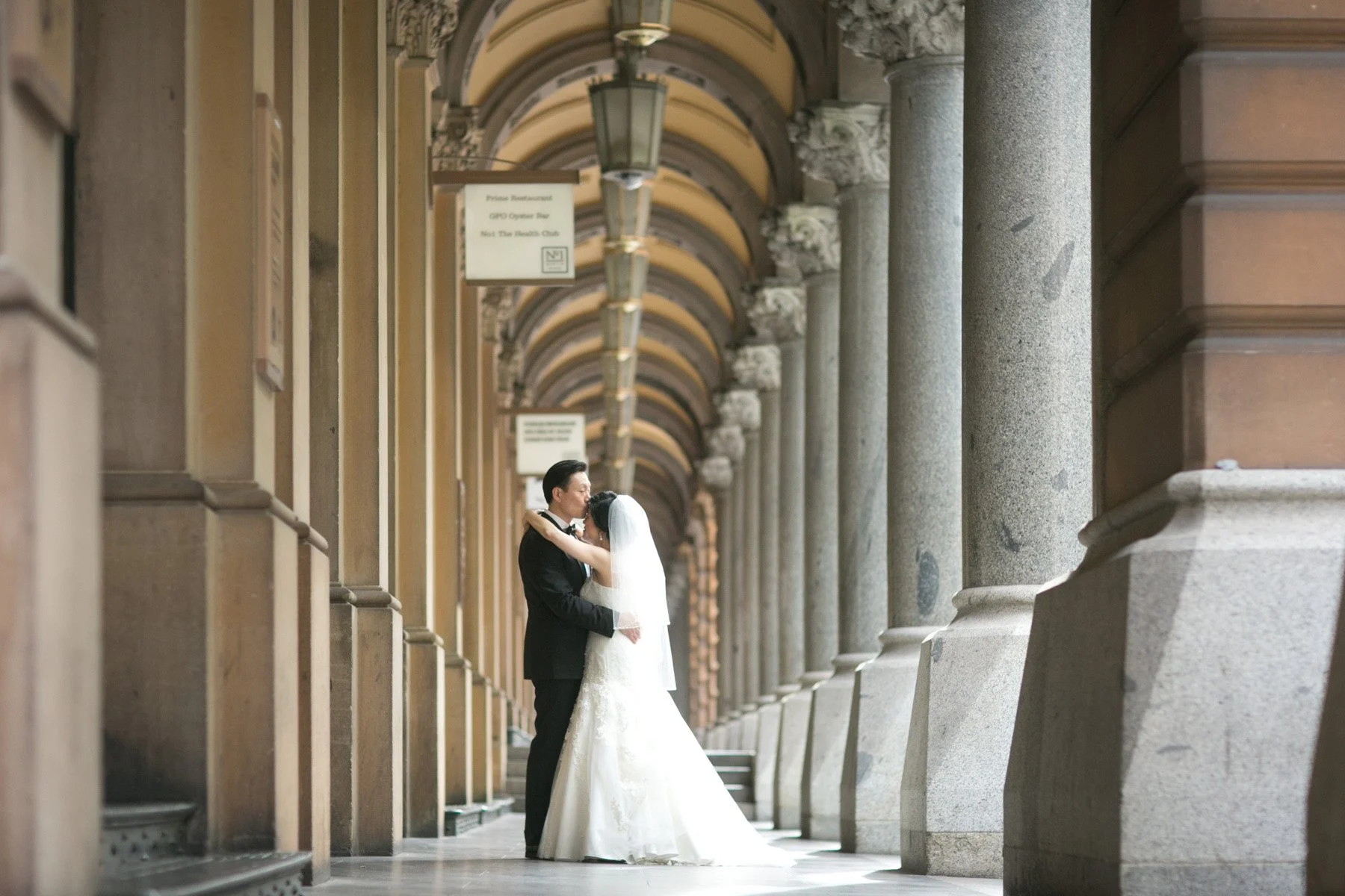 Bride and groom portraits beneath GPO arches, Martin Place Sydney
