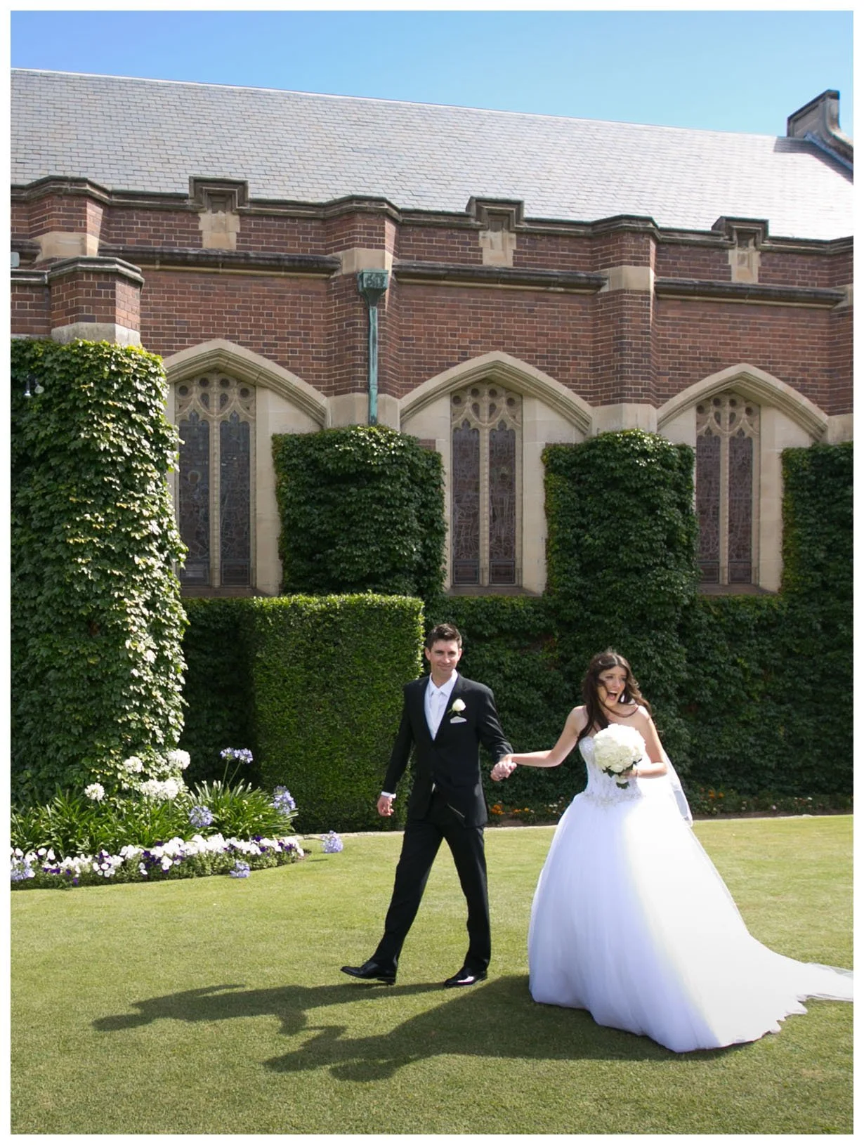 Candid bridal portrait on lawn outside Shore School Chapel, North Sydney