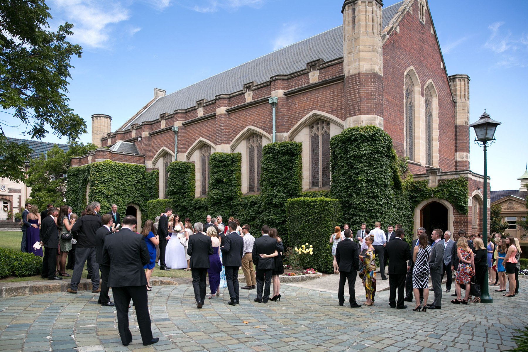 Guests mingling after ceremony at Shore School Chapel grounds, North Sydney
