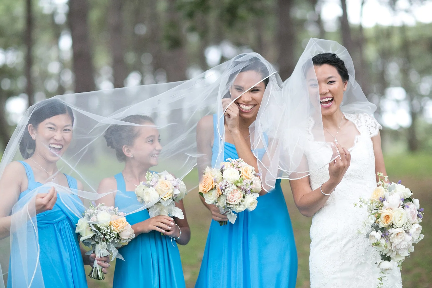 Bride and bridesmaids veil play Centennial Park Sydney wedding portrait session