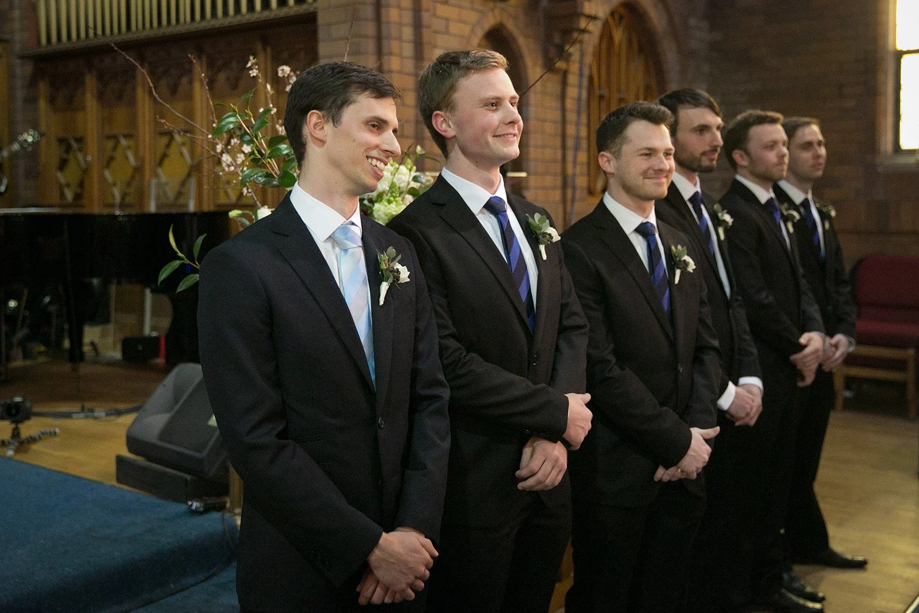 Groom and groomsmen lined up and smiling at the altar, St Andrews Anglican Church Roseville