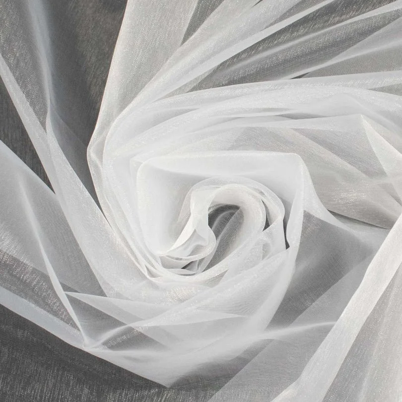 Close-up of sheer white fabric draped in a swirling pattern, resembling a spiral or rose.