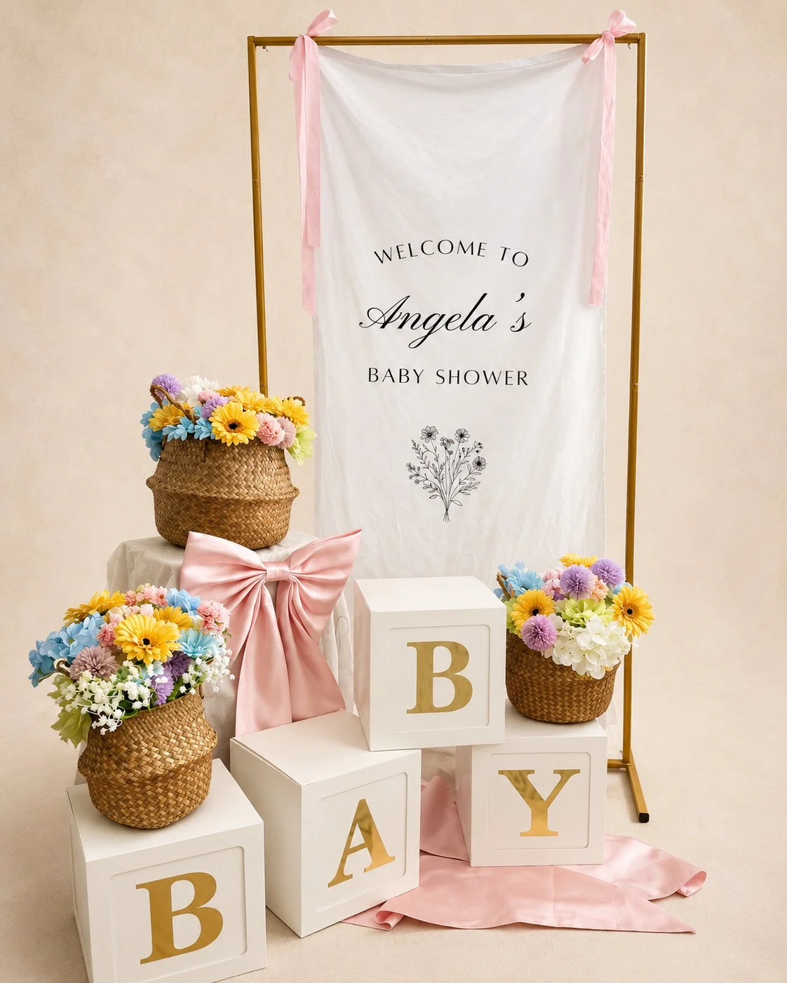 Decorative setup for a baby shower with a white banner reading 'BABY wong,' floral arrangements, and a cake with floral decorations on a table.