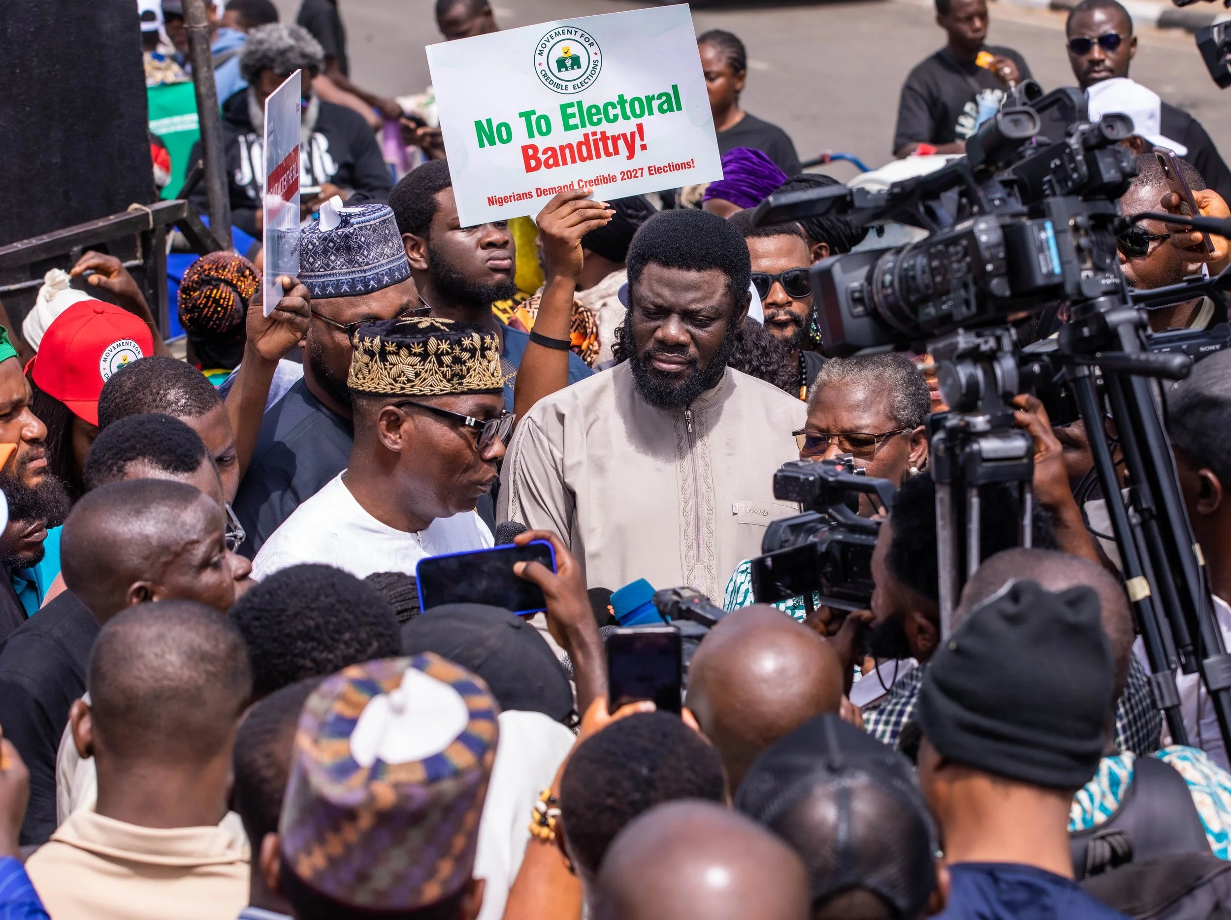 Prince Adewole Adebayo speaking to supporters with Prophet Issa El-Buba at the protest against the removal of the mandatory electronic transmission of voting results.