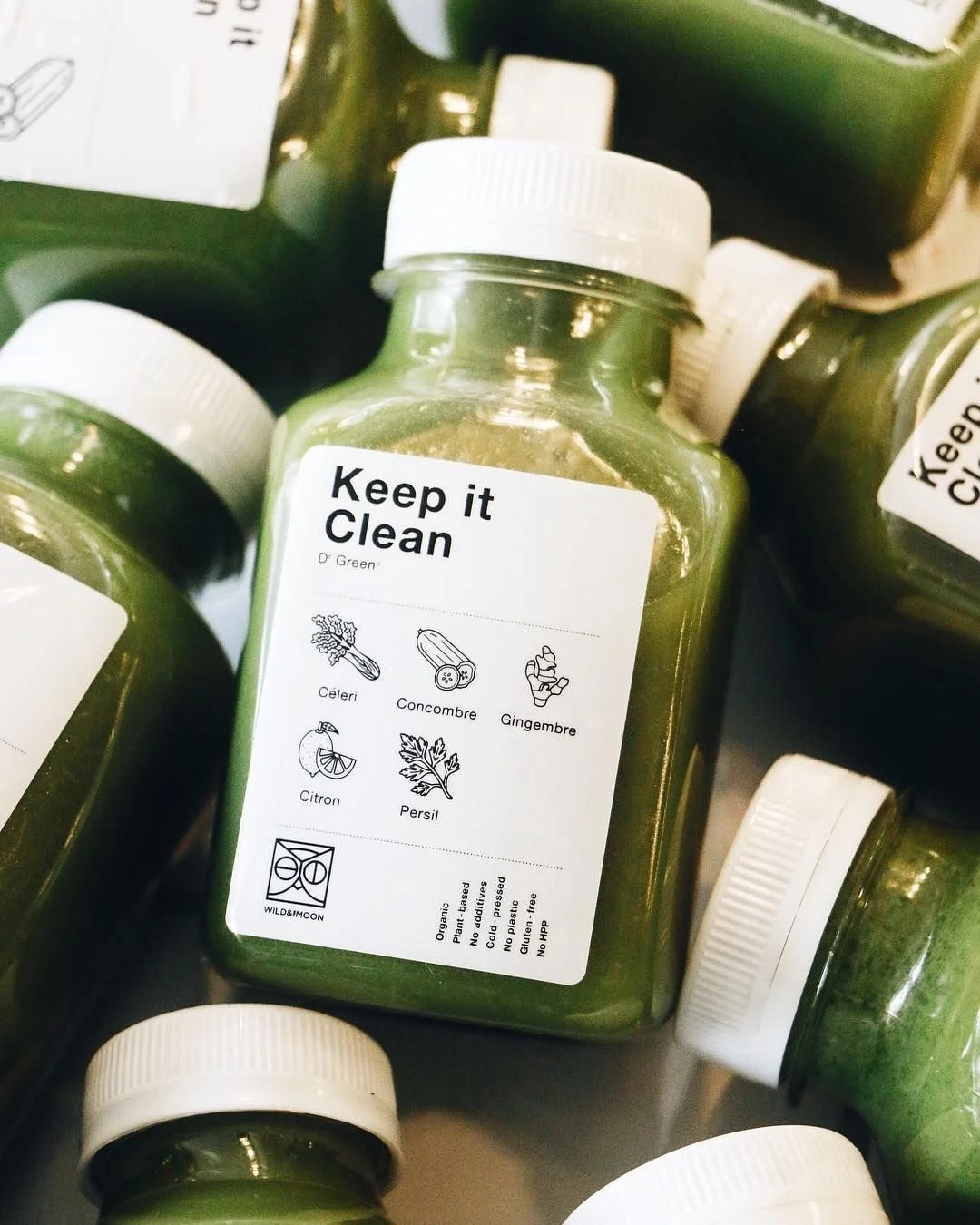 Cold-pressed juice bottle with illustrated label design for Wild & The Moon.