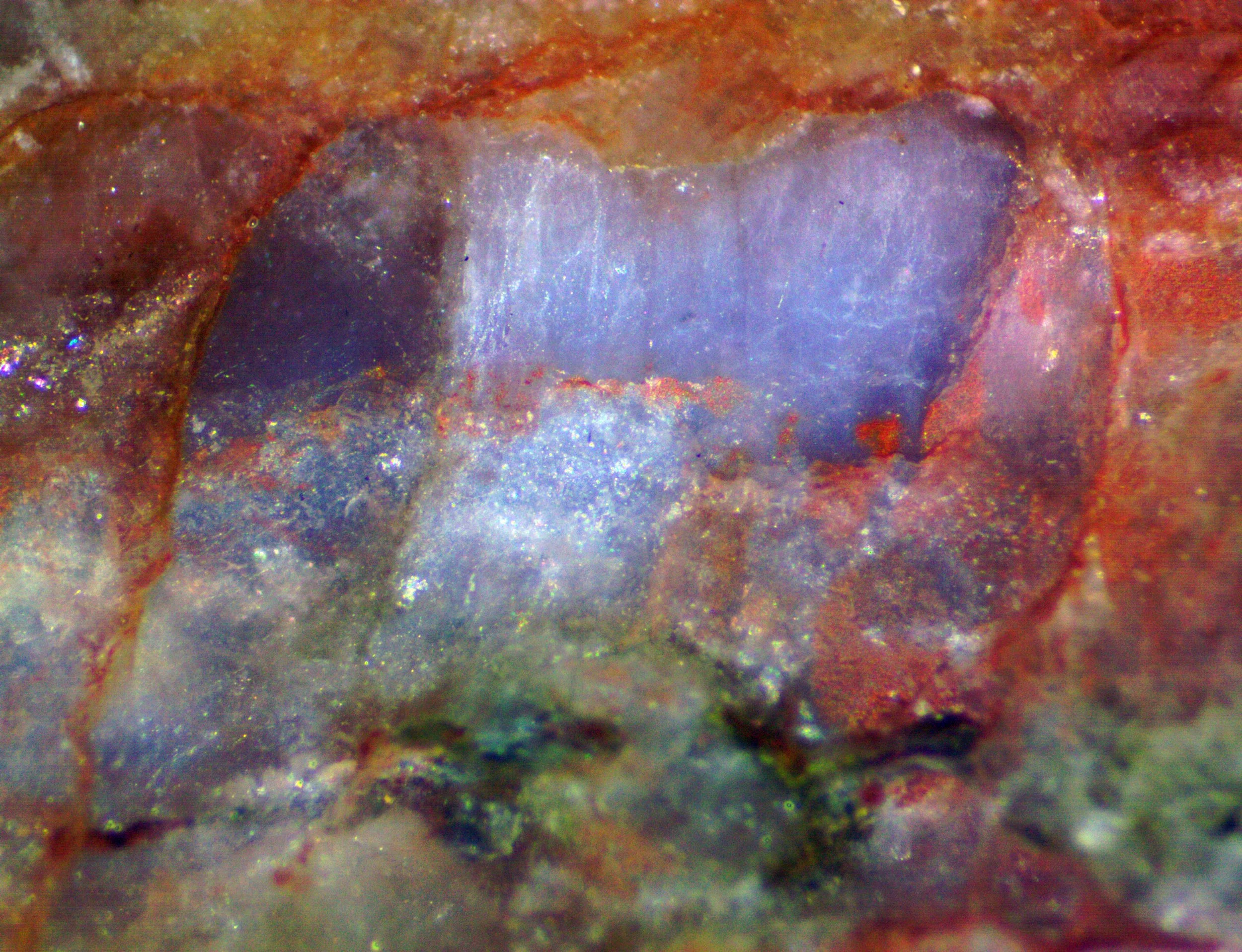 Polished section of the Milbank granite (South Dakota, USA) showing blue qaurtz with characteristic chatoyancy caused by exolved rutile needles.