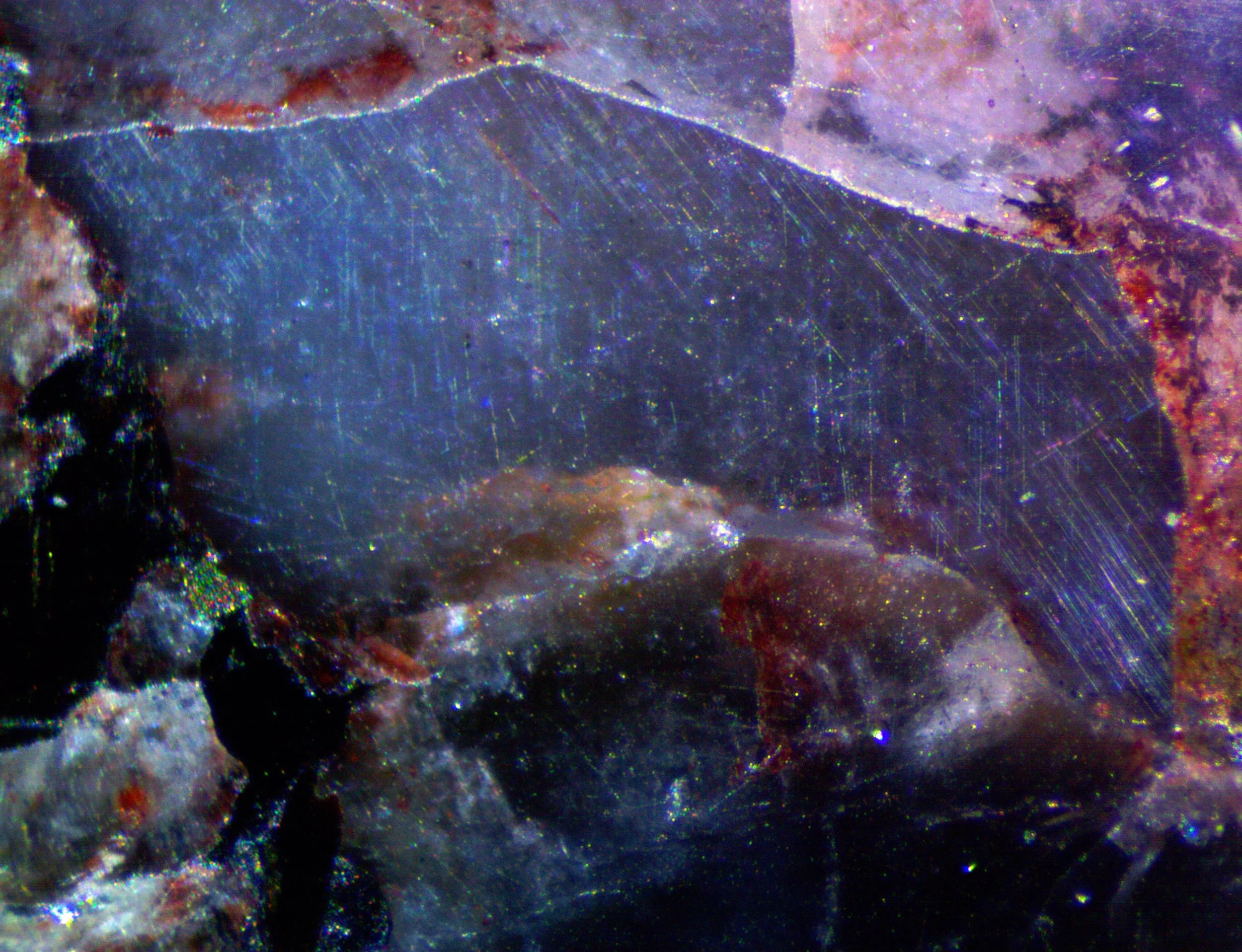 Polished section of the Milbank granite (South Dakota, USA) showing blue qaurtz with characteristic chatoyancy caused by exolved rutile needles.