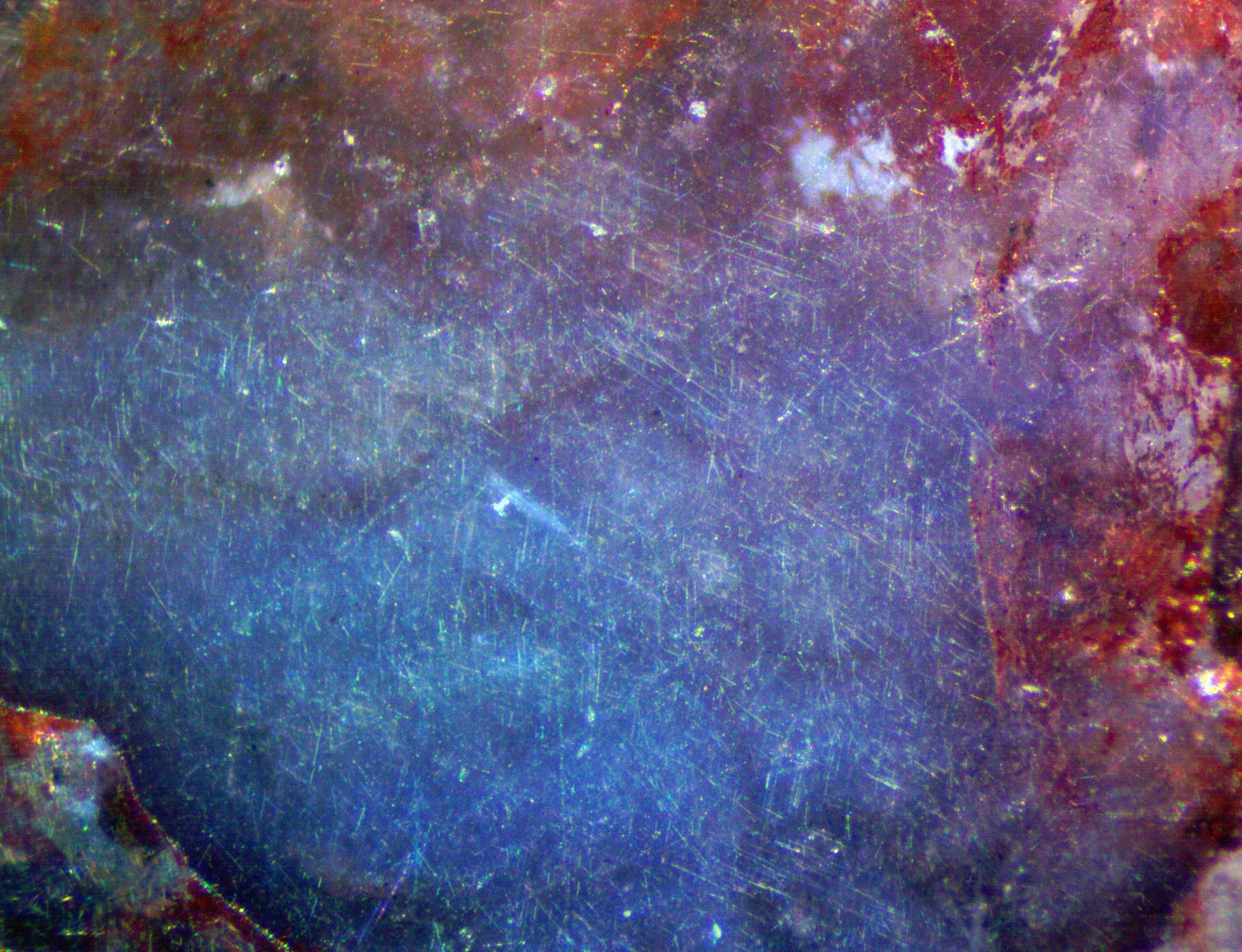 Polished section of the Milbank granite (South Dakota, USA) showing blue qaurtz with characteristic chatoyancy caused by exolved rutile needles.