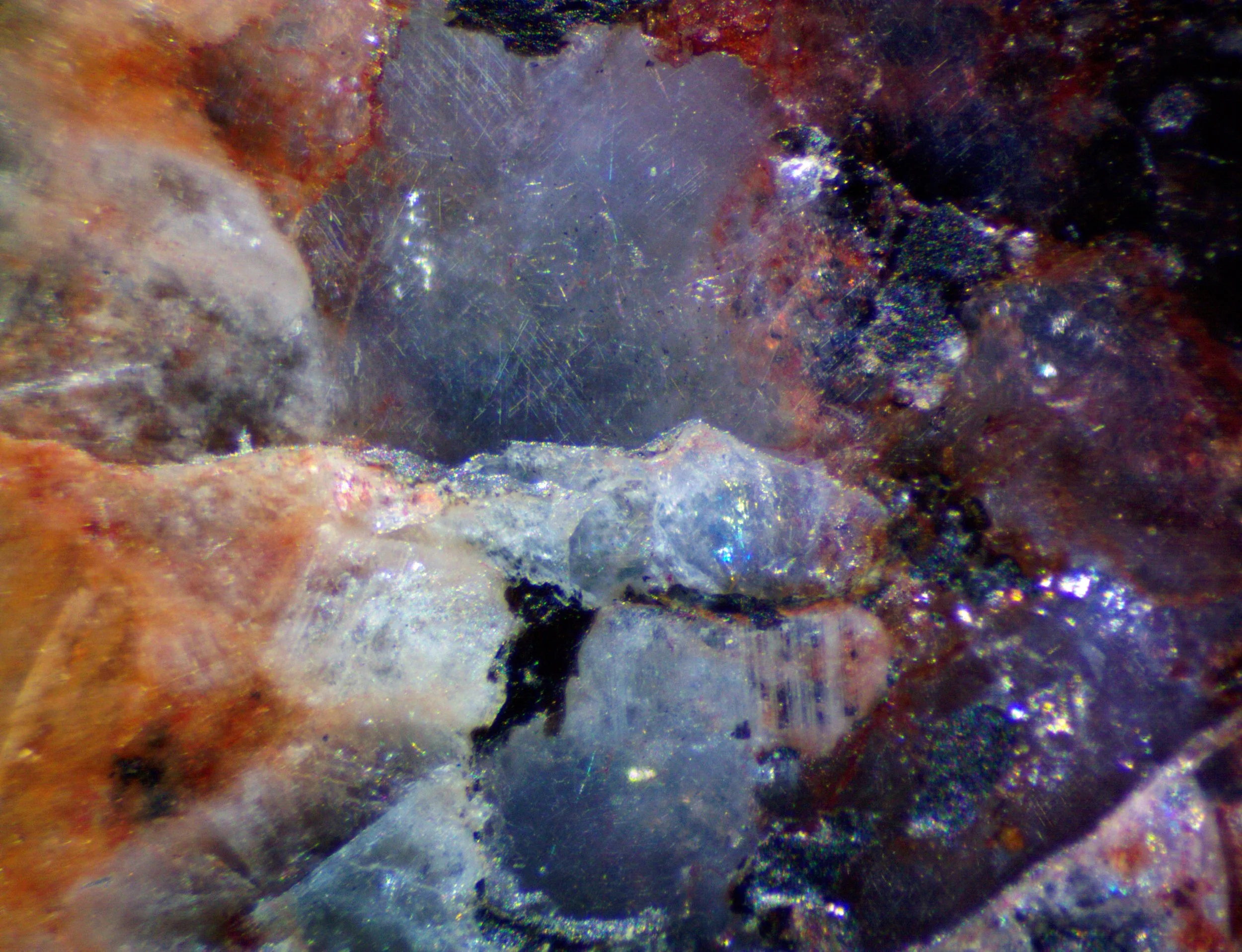 Polished section of the Milbank granite (South Dakota, USA) showing blue qaurtz with characteristic chatoyancy caused by exolved rutile needles.