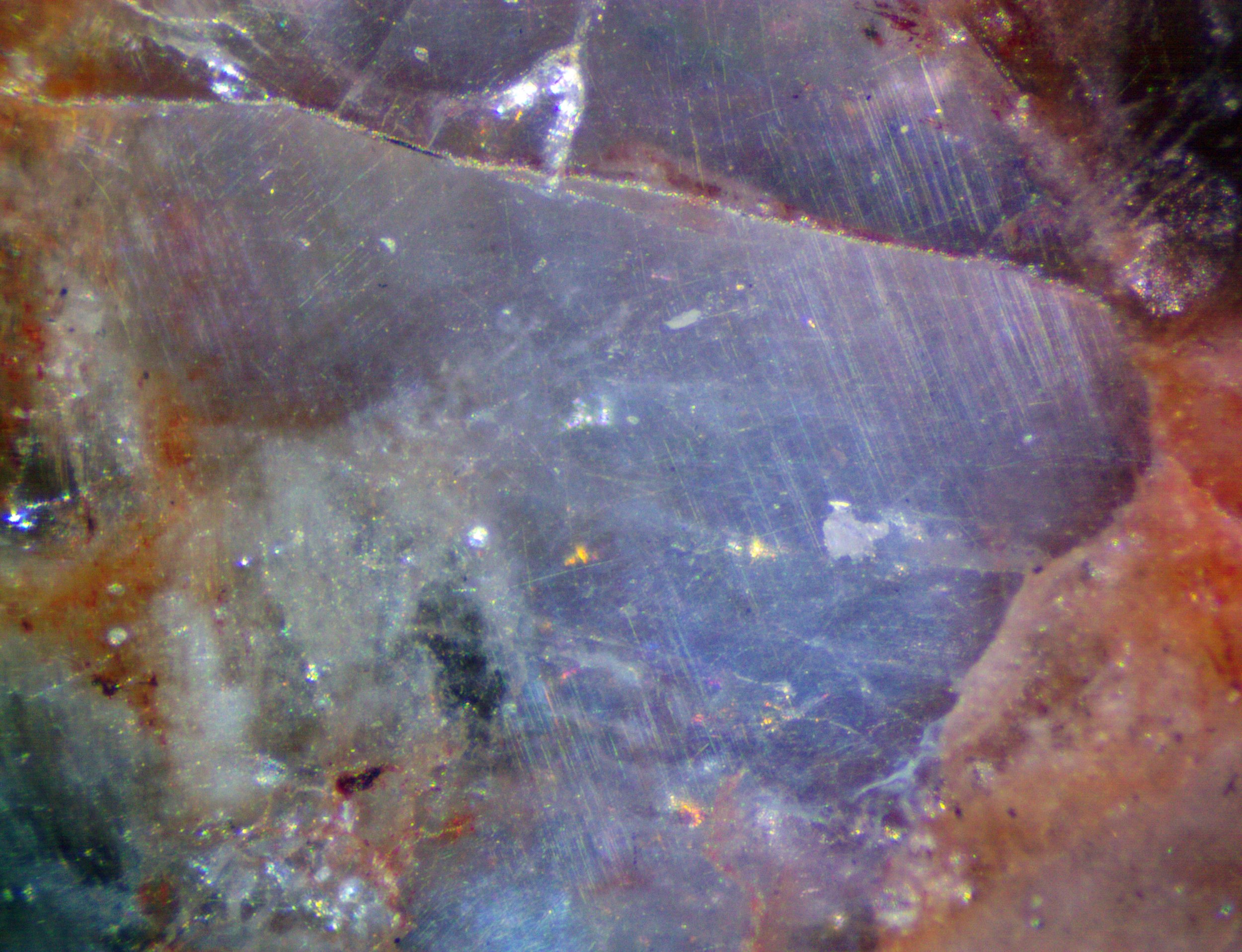 Polished section of the Milbank granite (South Dakota, USA) showing blue qaurtz with characteristic chatoyancy caused by exolved rutile needles.