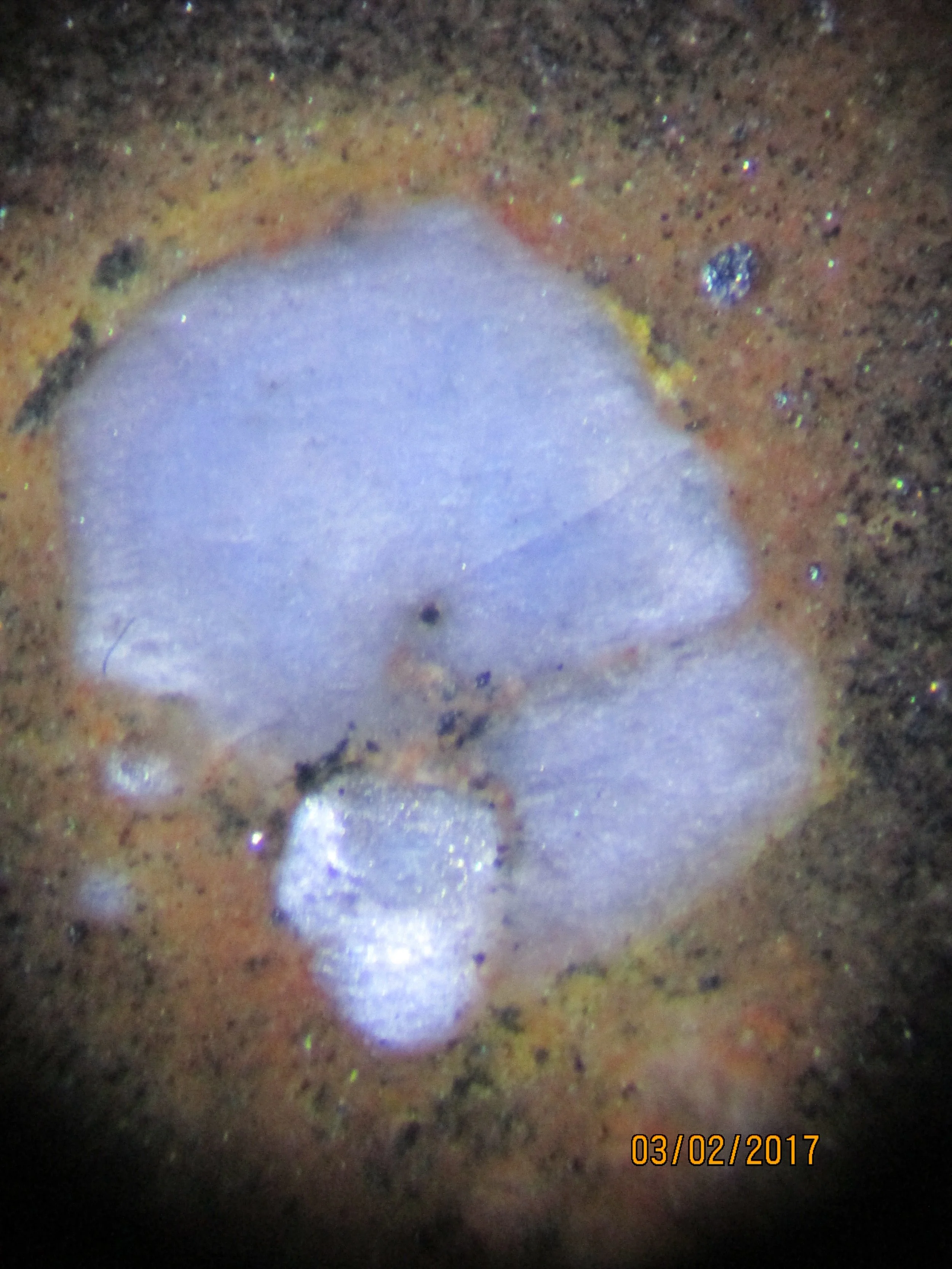 Polished section of the Llano rhyolite (Texas, USA) showing its characteristic chatoyancy caused by submicron ilmenite inclusions.