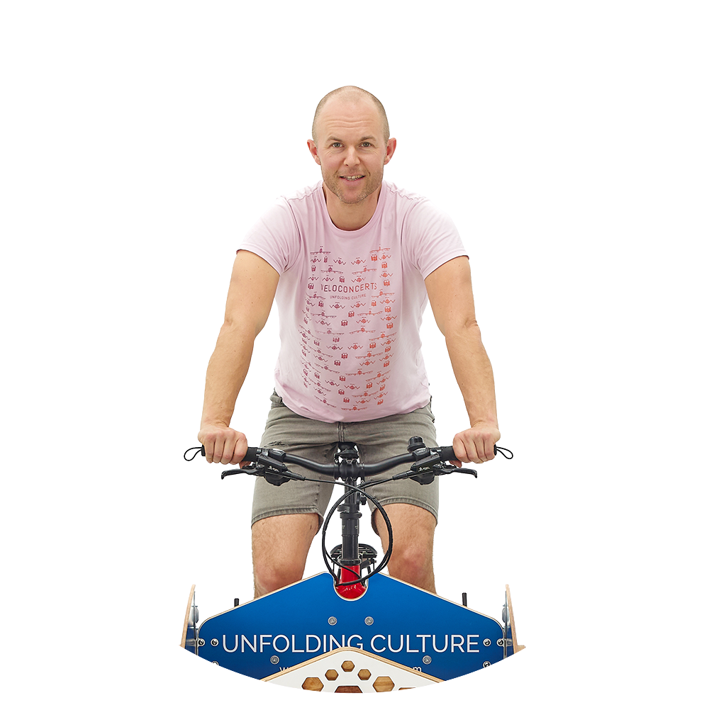 Jonas Skielboe, CEO of VeloConcerts riding a cargo bike that carries the VeloStage.