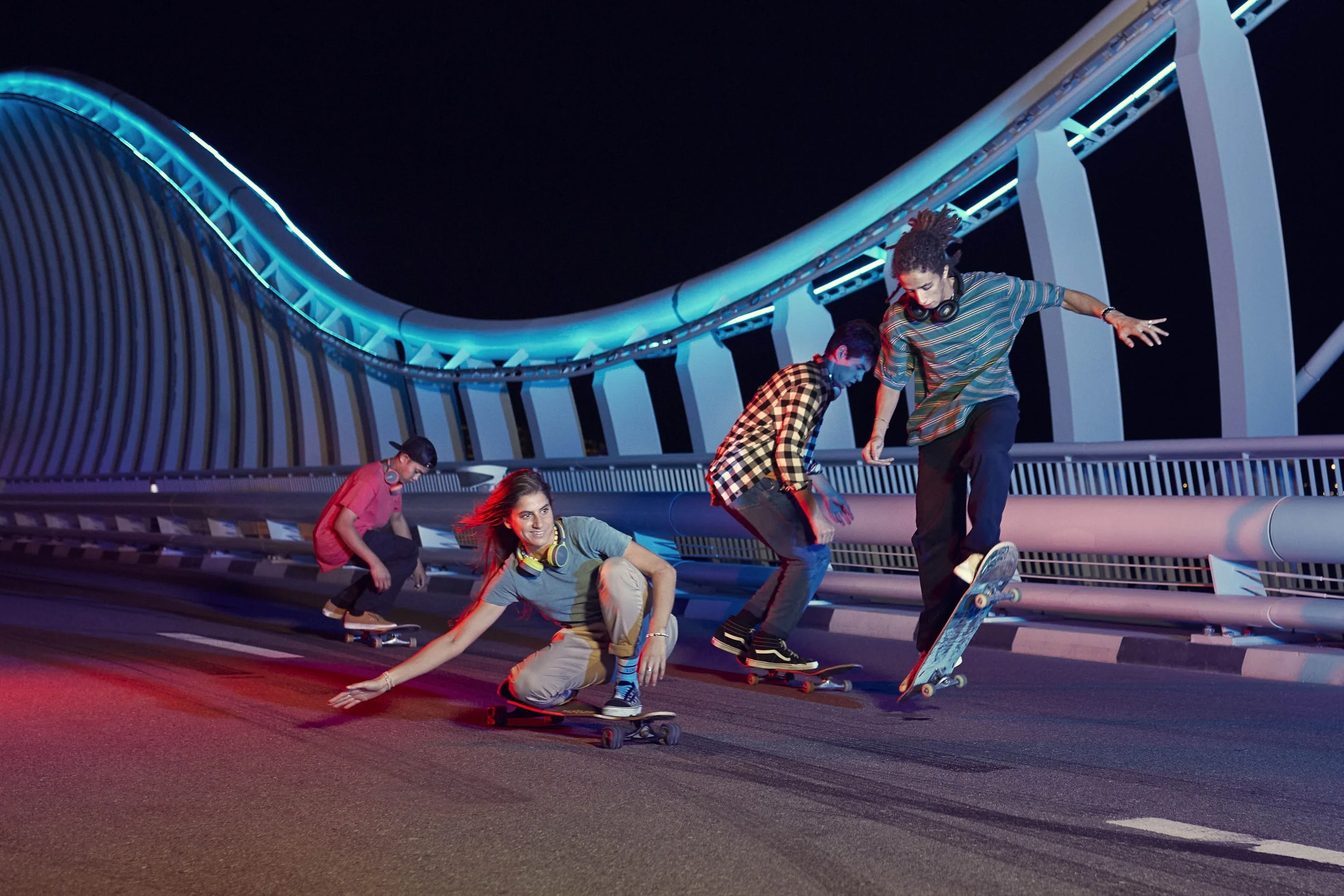 Skateboarders sake aross a bridge in Dubai at night in the advertising photo for Etisalat by Jon Enoch