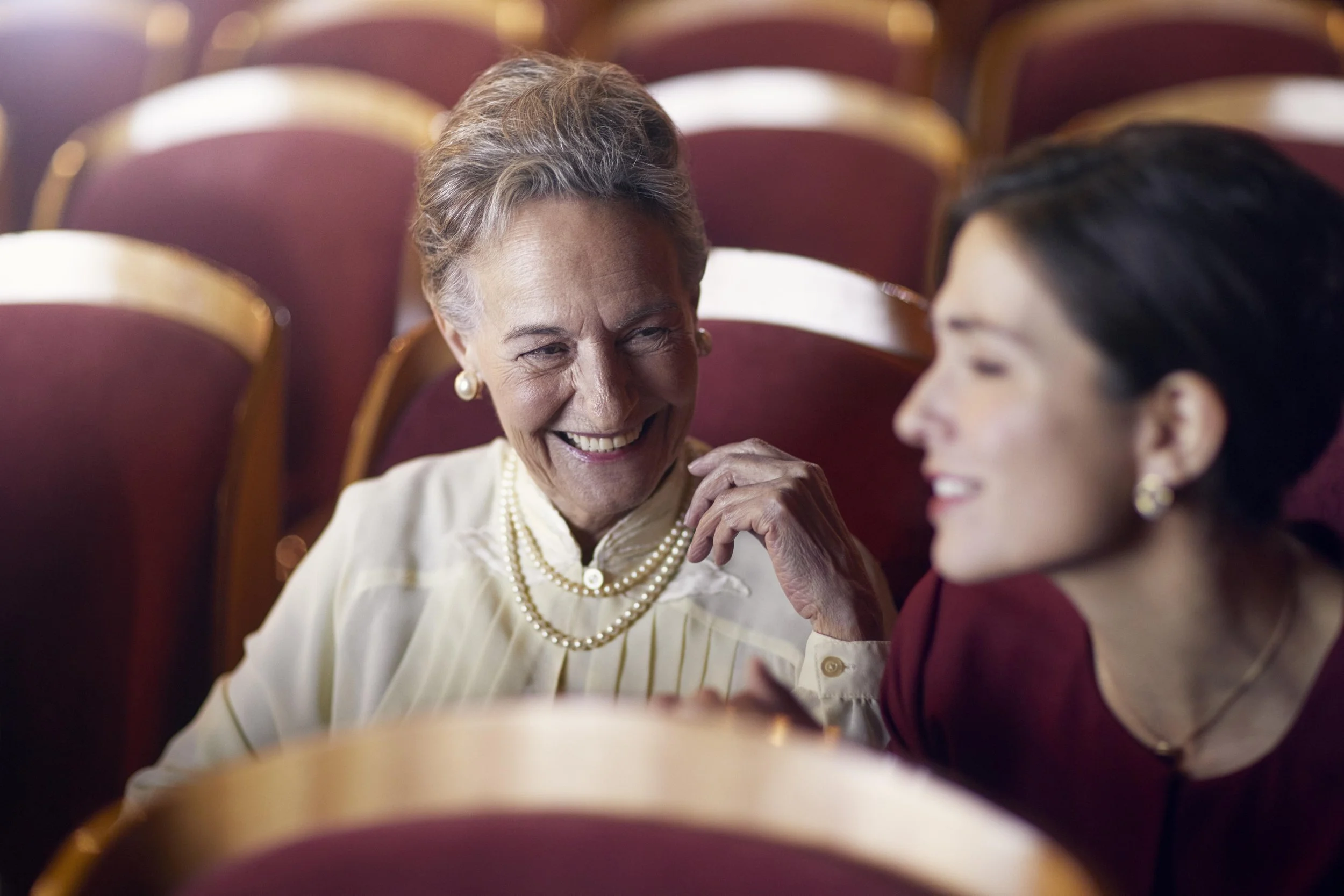 A mother and daughter enjoy time together at the theatre in this advertising image from lifestyle photographer Jon Enoch
