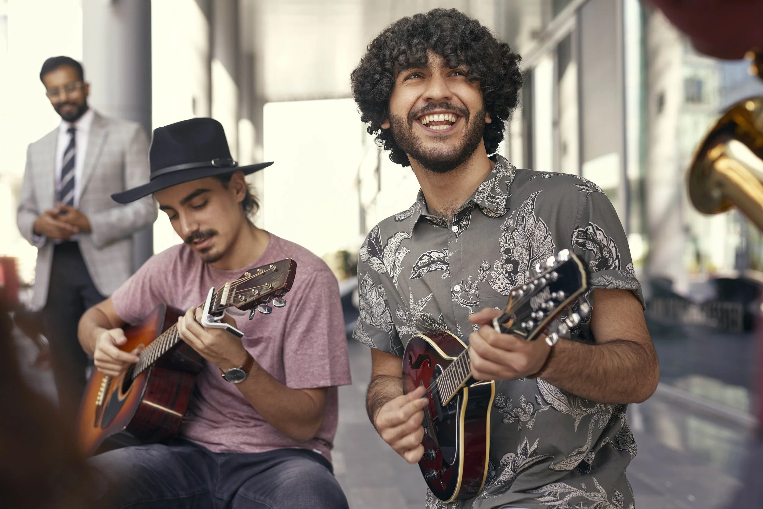 Street musicians busk in this lifestyle image by Jon Enoch