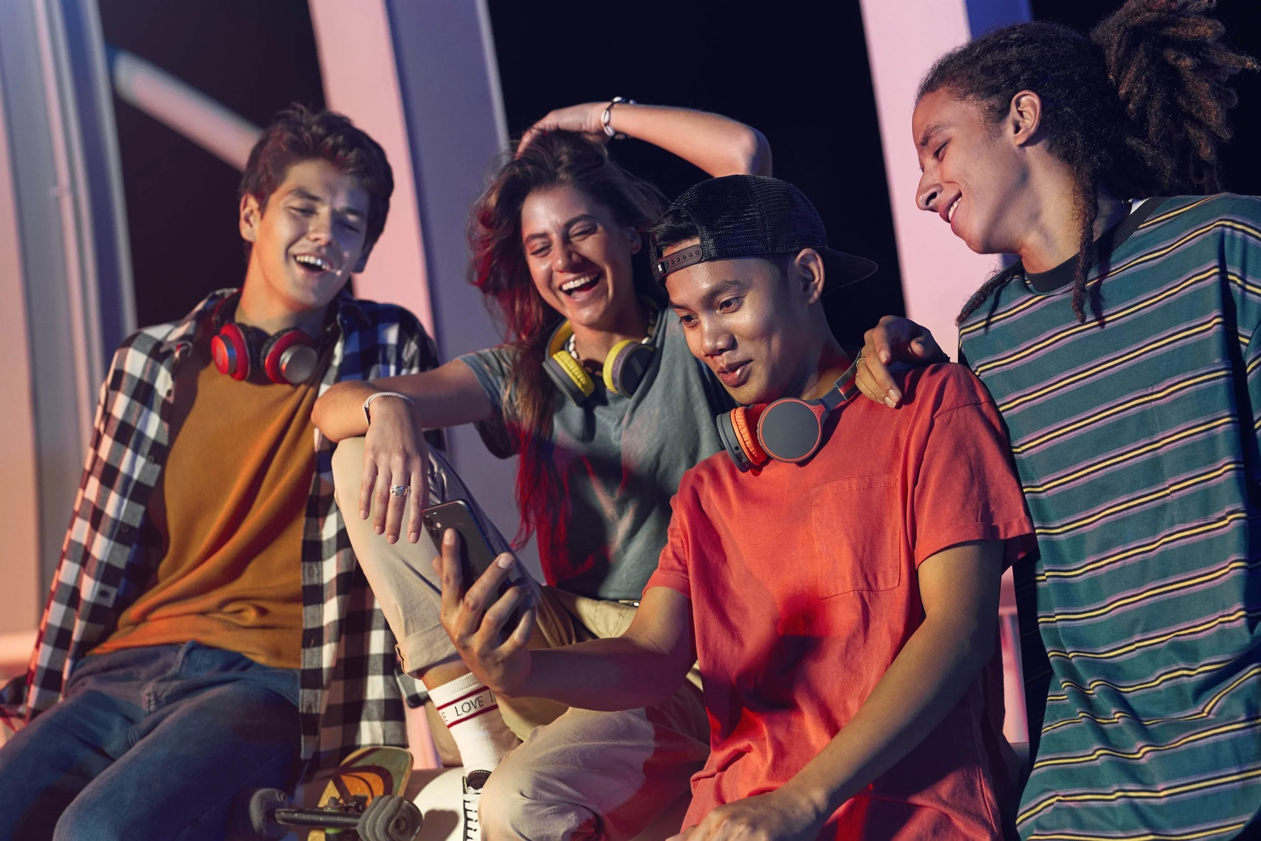 A group of teenagers watch a mobile phone in this advertising by photographer Jon Enoch